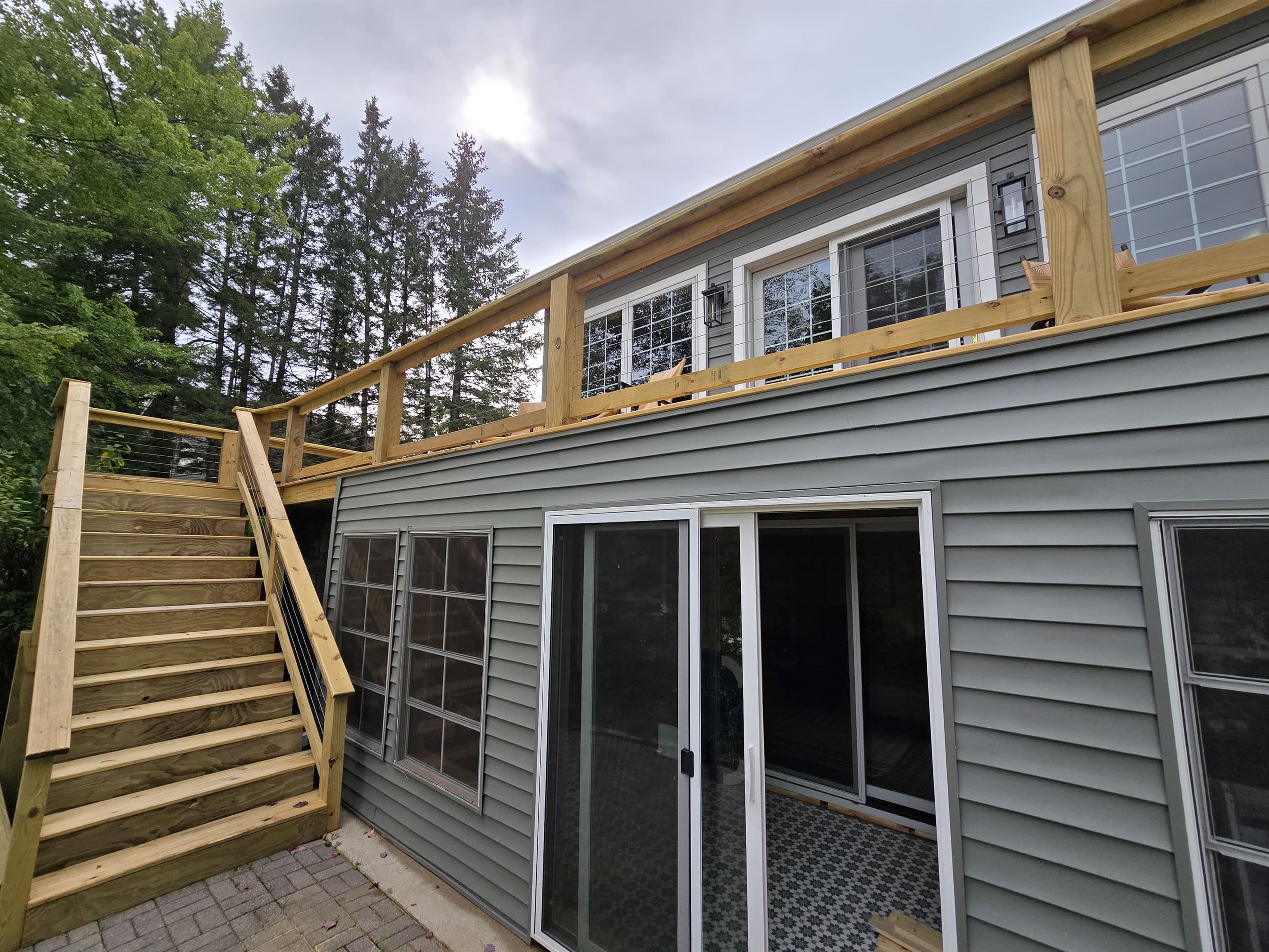 - Home exterior with spacious decks and stairs   - Easy access to lower lounge areas and the lake   - Great layout for enjoying indoor and outdoor spaces