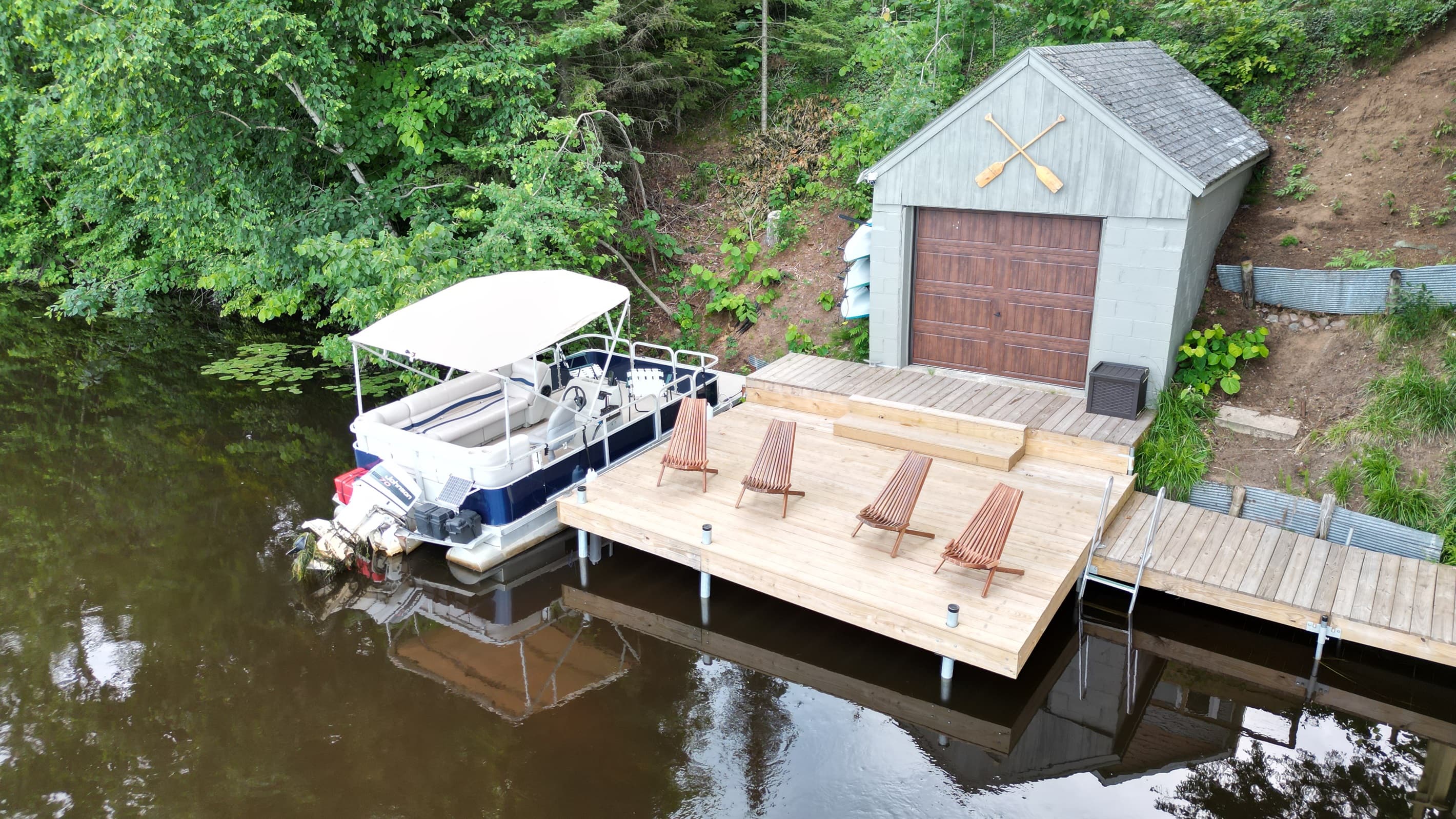 - Lakeside dock with pontoon and seating deck   - Relax in chairs overlooking calm reflective water   - A perfect waterfront hangout for sunny days