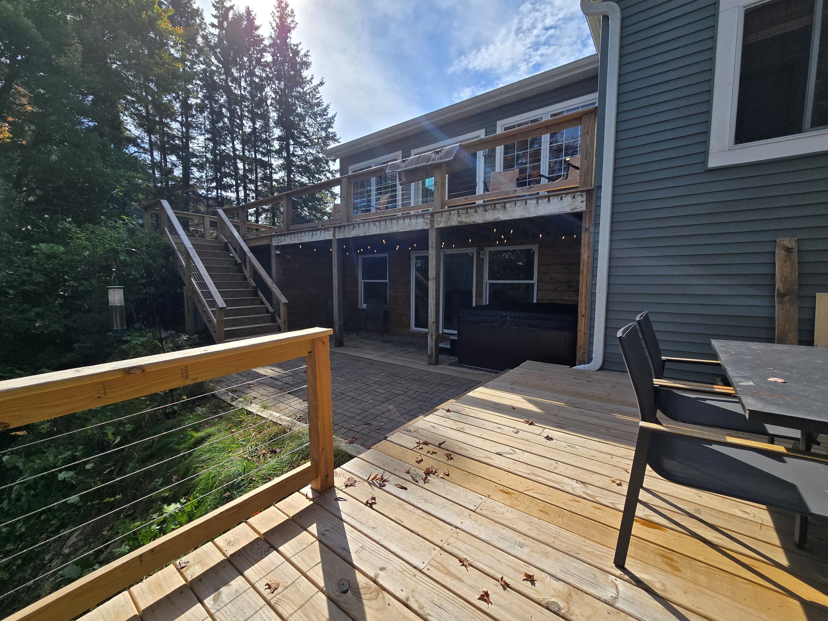 Unwind in our covered lakeside hot tub with stunning views! ✨ Enjoy bubbling water, peaceful nature, and vibrant trees—perfect for sunrise coffee or a relaxing sunset soak. 🌲🌅