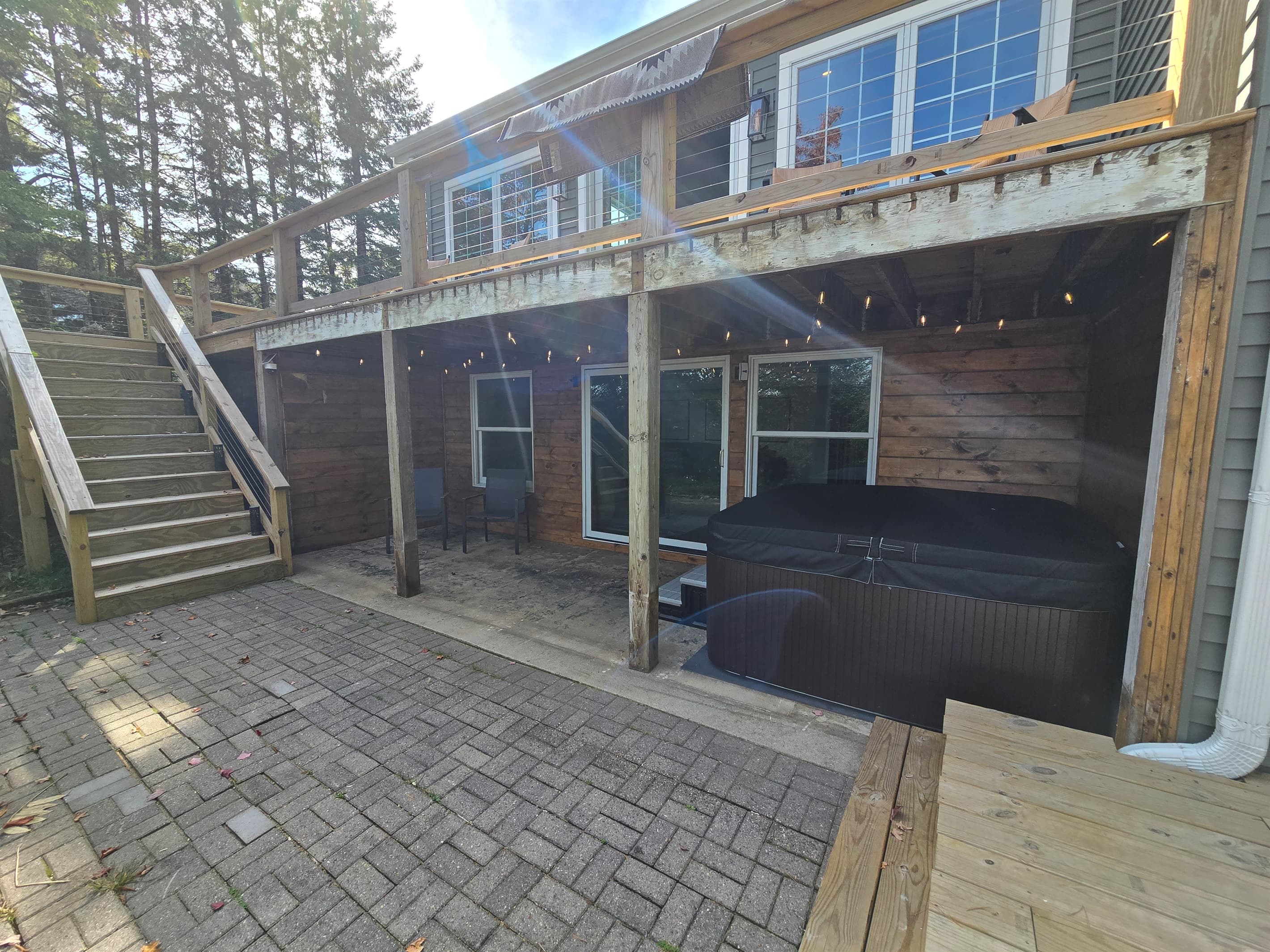 Unwind in our covered lakeside hot tub with stunning views! ✨ Enjoy bubbling water, peaceful nature, and vibrant trees—perfect for sunrise coffee or a relaxing sunset soak. 🌲🌅