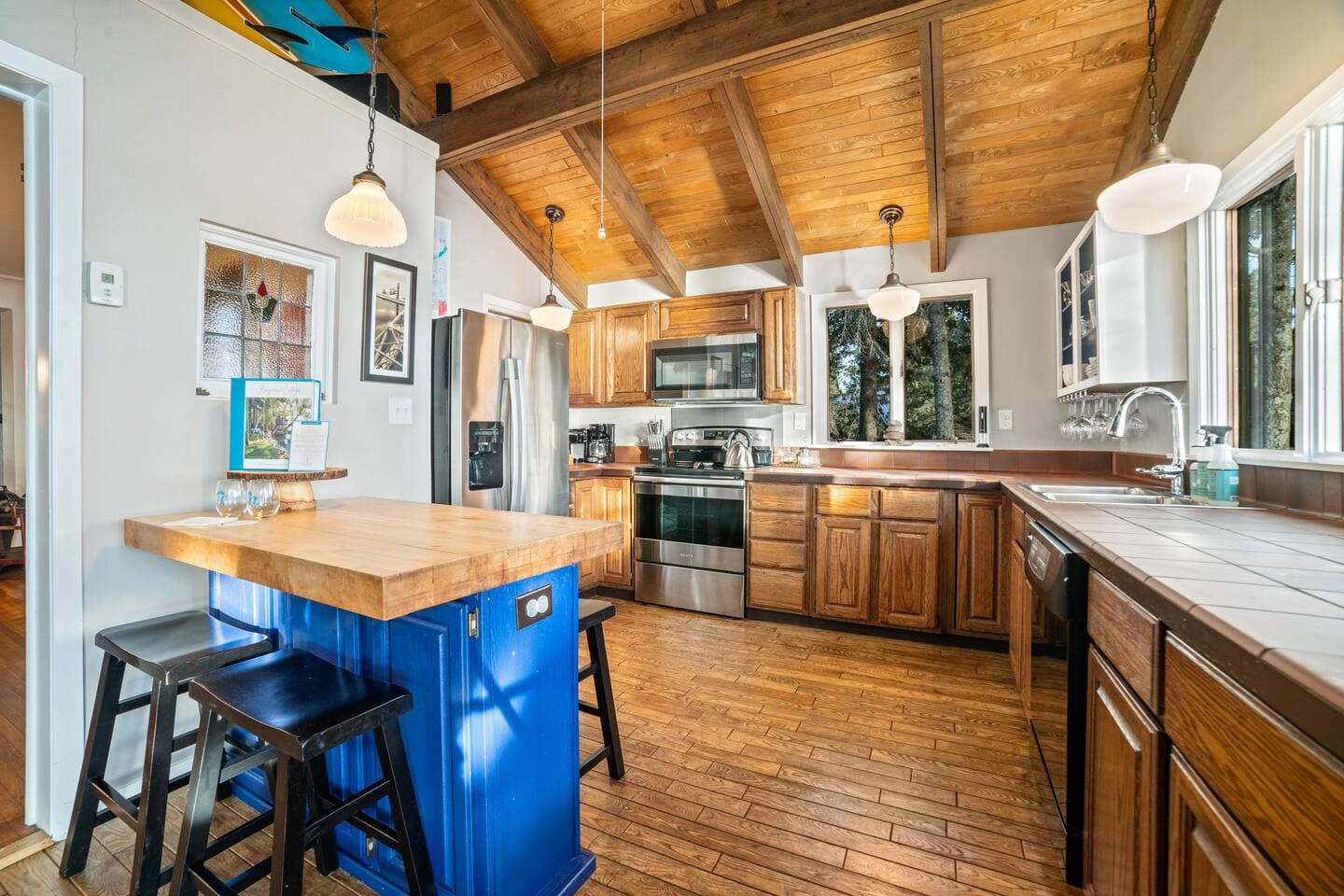 The home is stocked and ready for your arrival!  Enjoy cooking in the kitchen with the wall of windows that overlook Superior Bay with new stainless-steel kitchen appliances. 