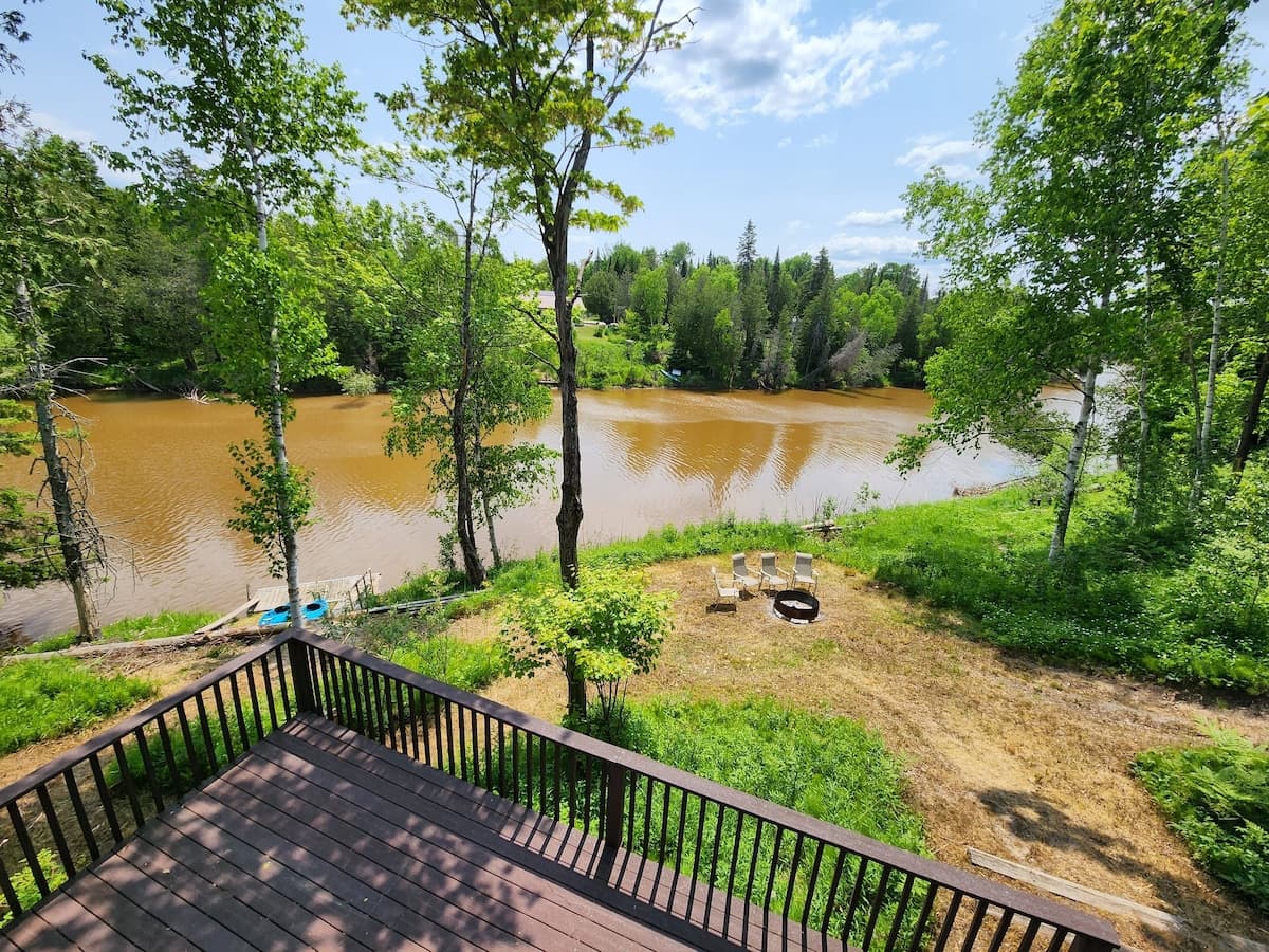 Upper deck view of the river and dock with Kayaks for guest use late May to October.