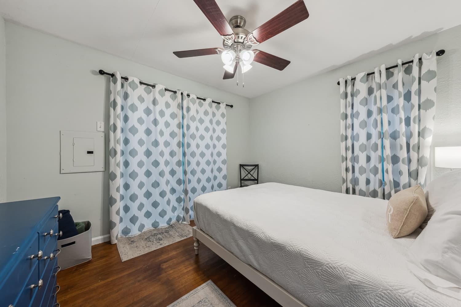 Primary bedroom with large window and patio door for walk out to back yard