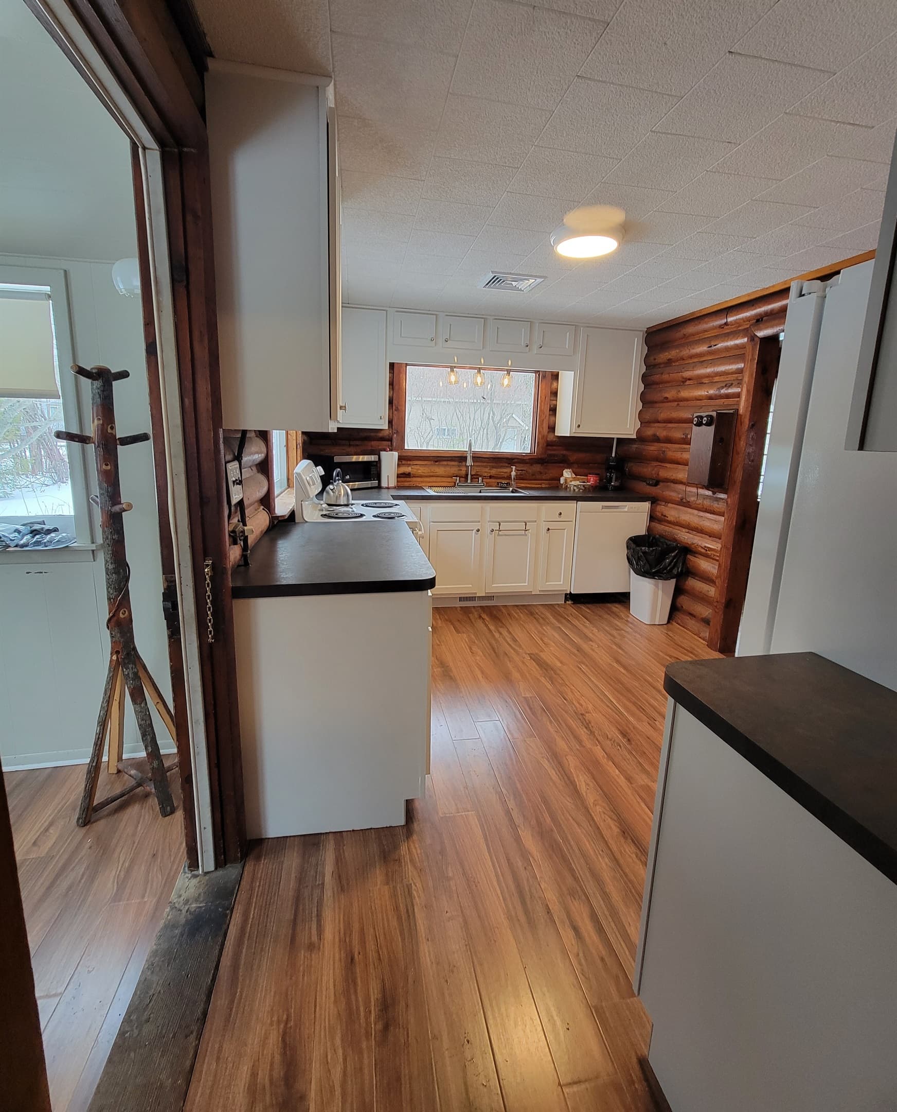 Kitchen is equipped with a large refrigerator and dishwasher