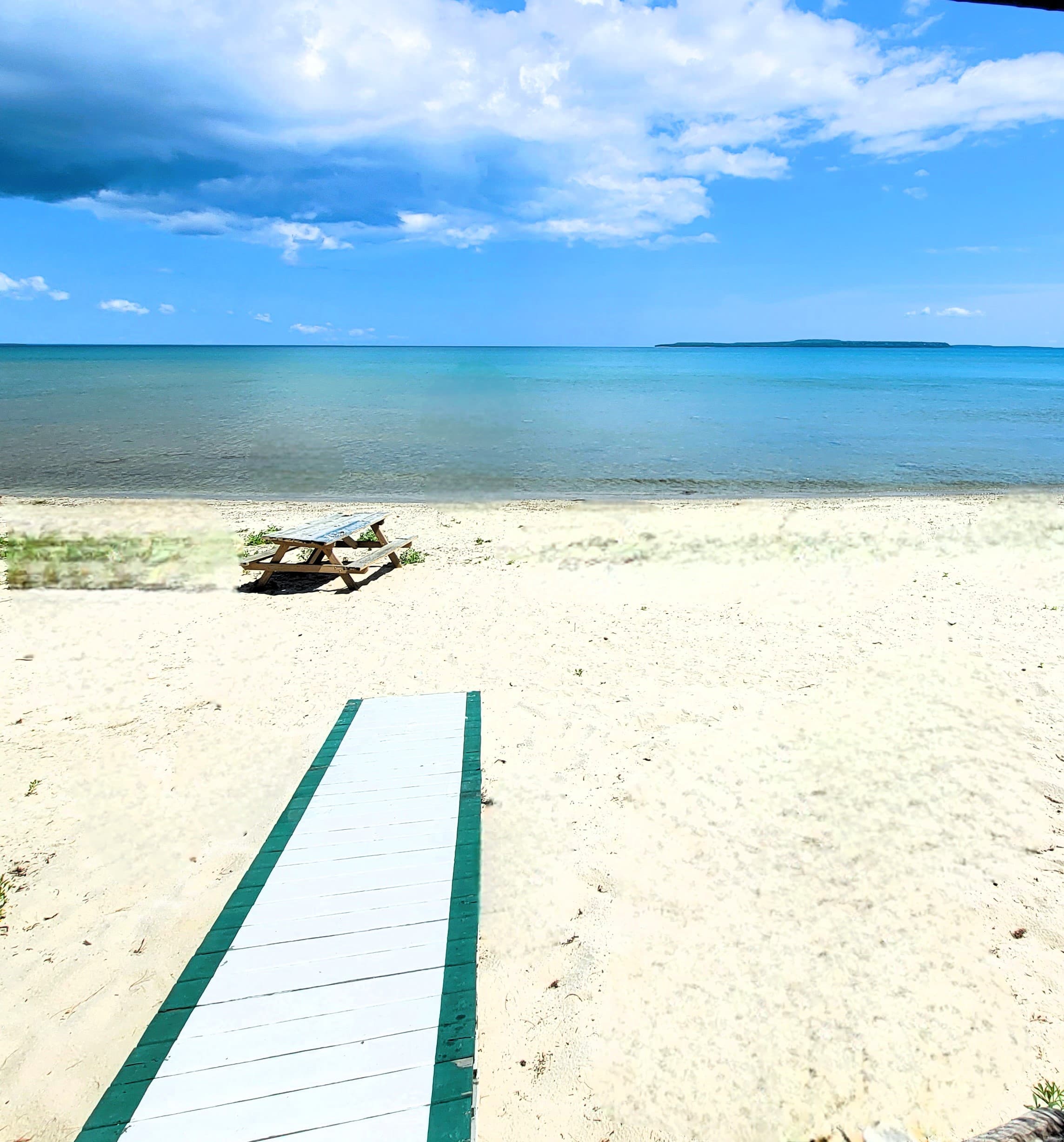 From the house it is about 20 steps and your feet are in the soft sand.  Mackinac Island in the distance