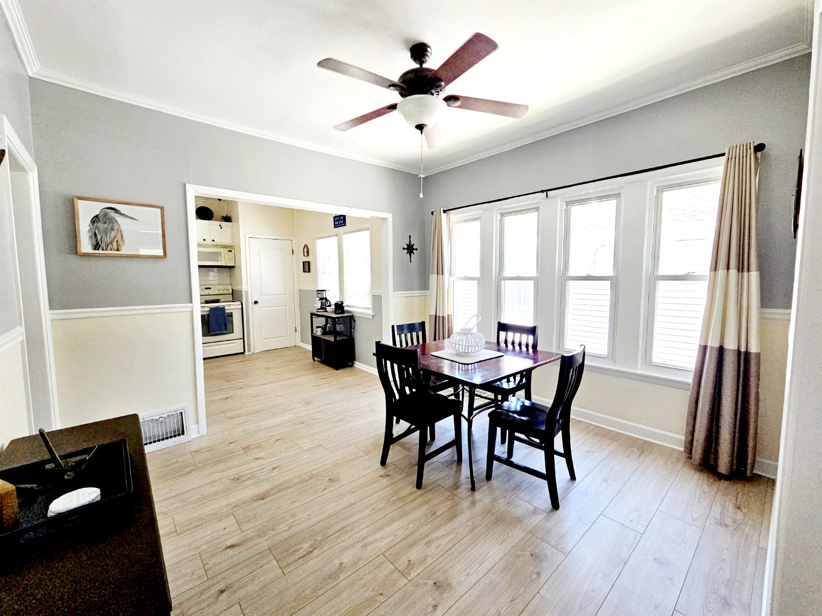 Formal dining room with large, bright windows