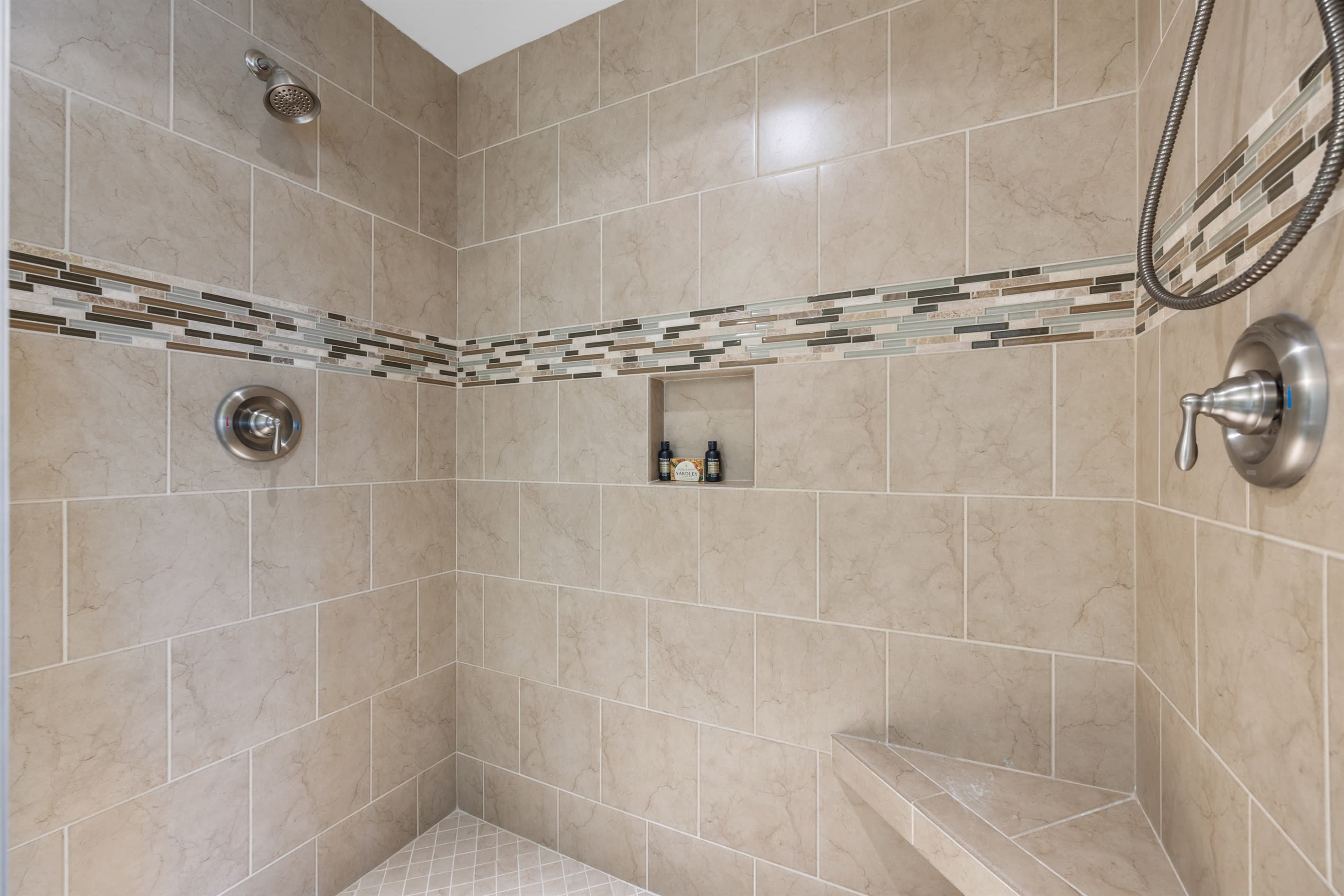 Spa-style shower w/ stone tile for a soothing rinse.