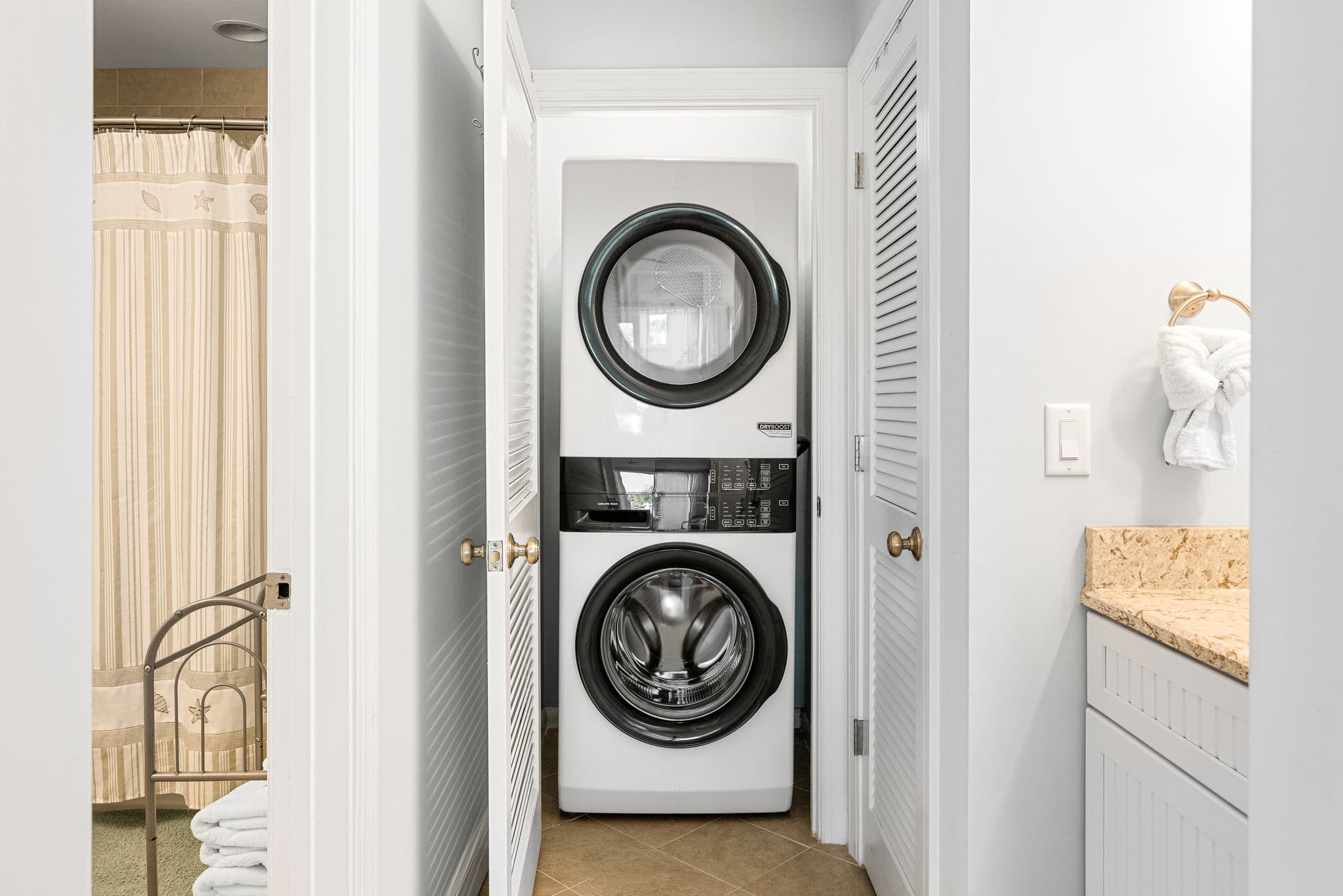 Handy laundry station w/ washer, dryer & storage.