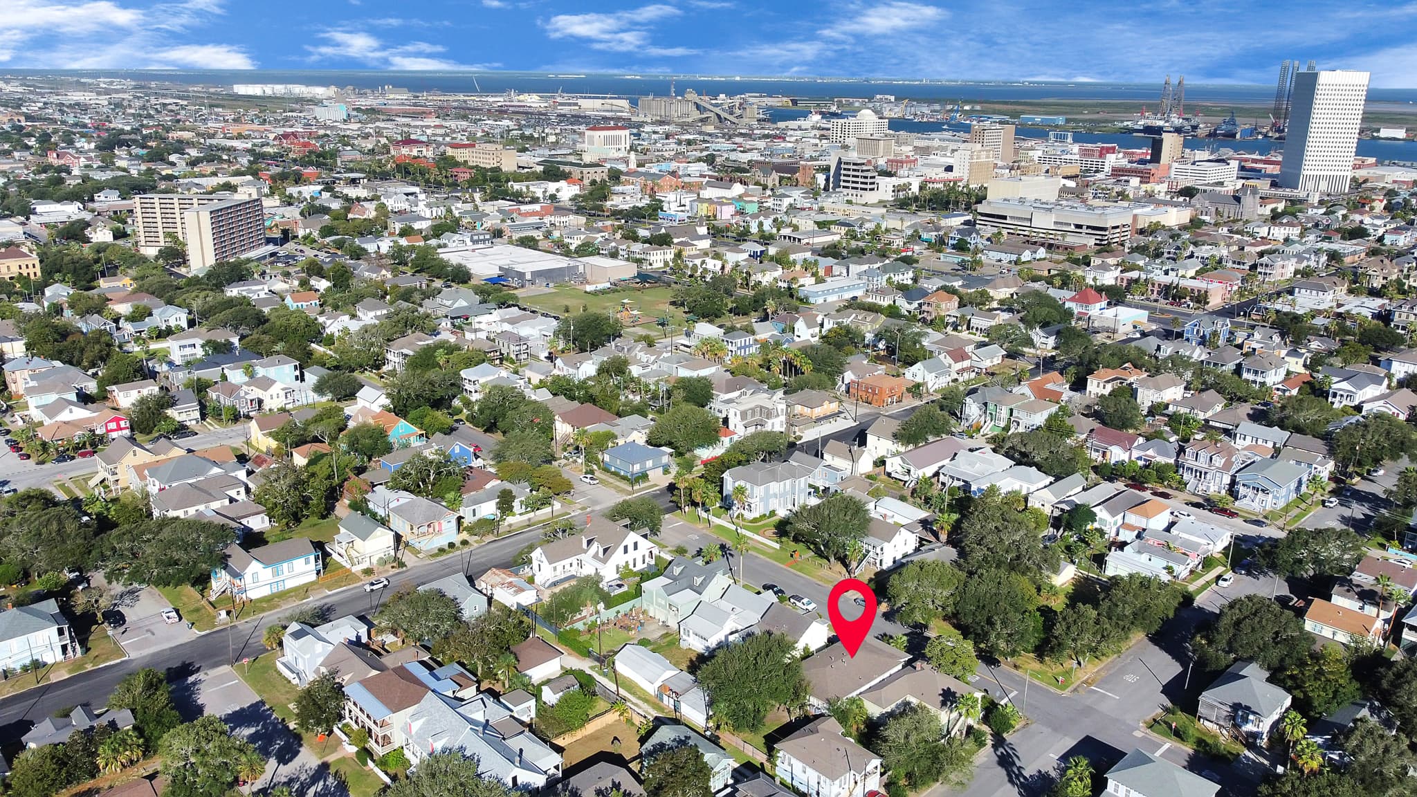 Galveston's historic East End from above — tree-lined streets, classic architecture, and the Gulf of Mexico just around the corner from your stay.