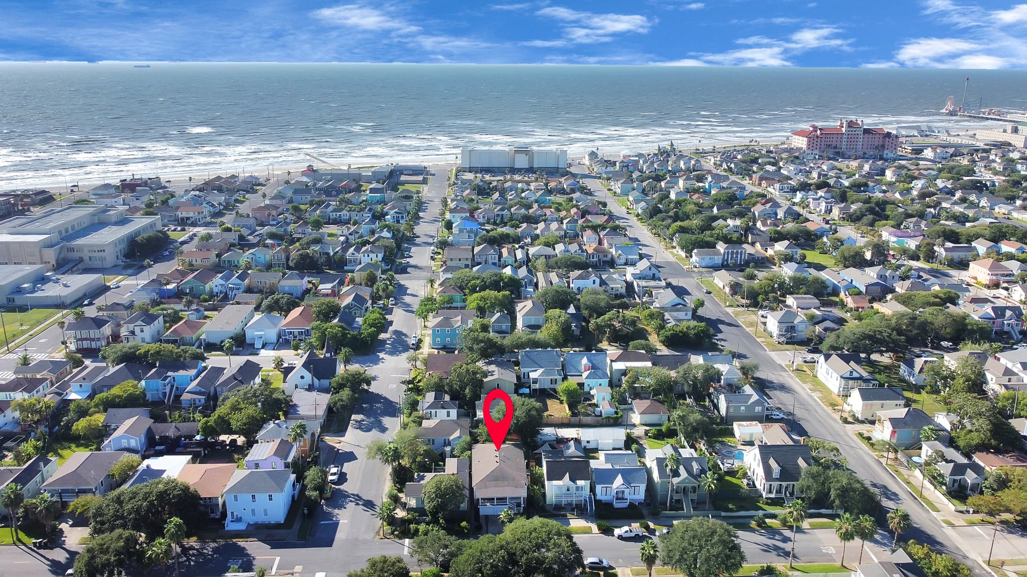 From above, Galveston's East End reveals its scale — historic neighborhoods, lush canopy streets, and the Gulf just blocks from 1705 Avenue M.