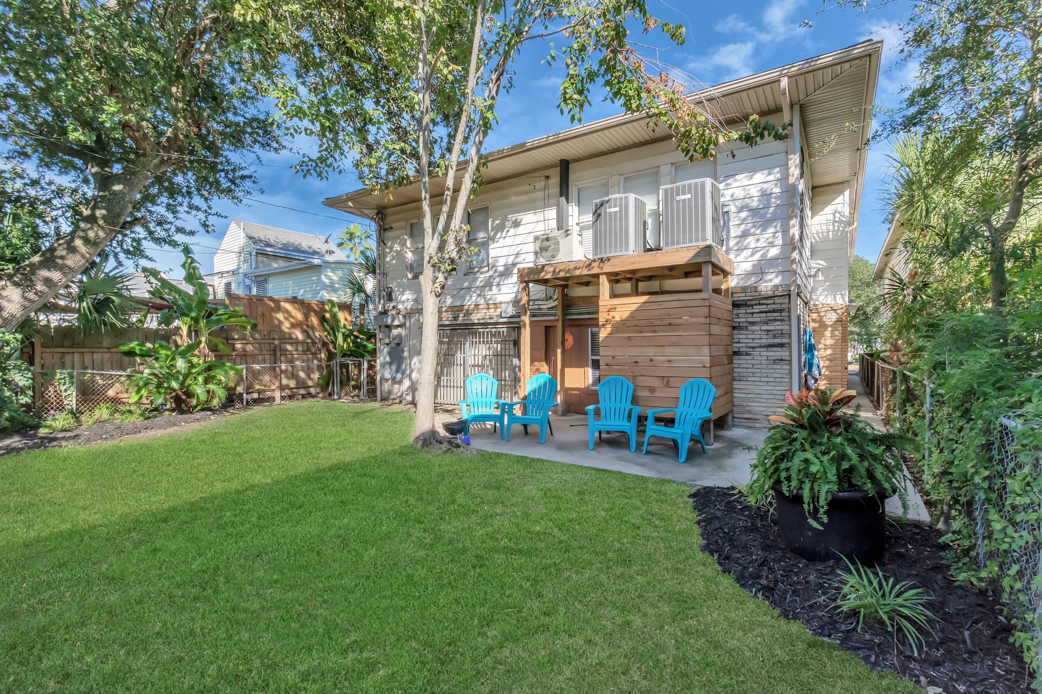 A generous shared yard with room to breathe — kick back in the shade, let the dog run, and enjoy the calm pace of island living.