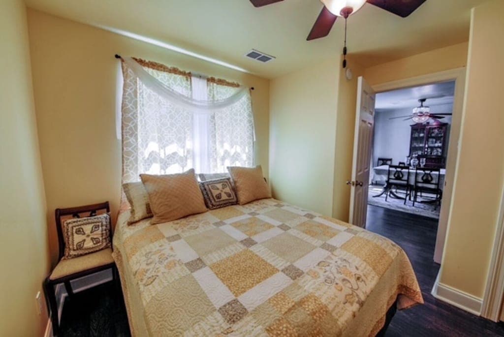 Right off the main entryway, the charming second bedroom offers a cozy double bed and a restful retreat.