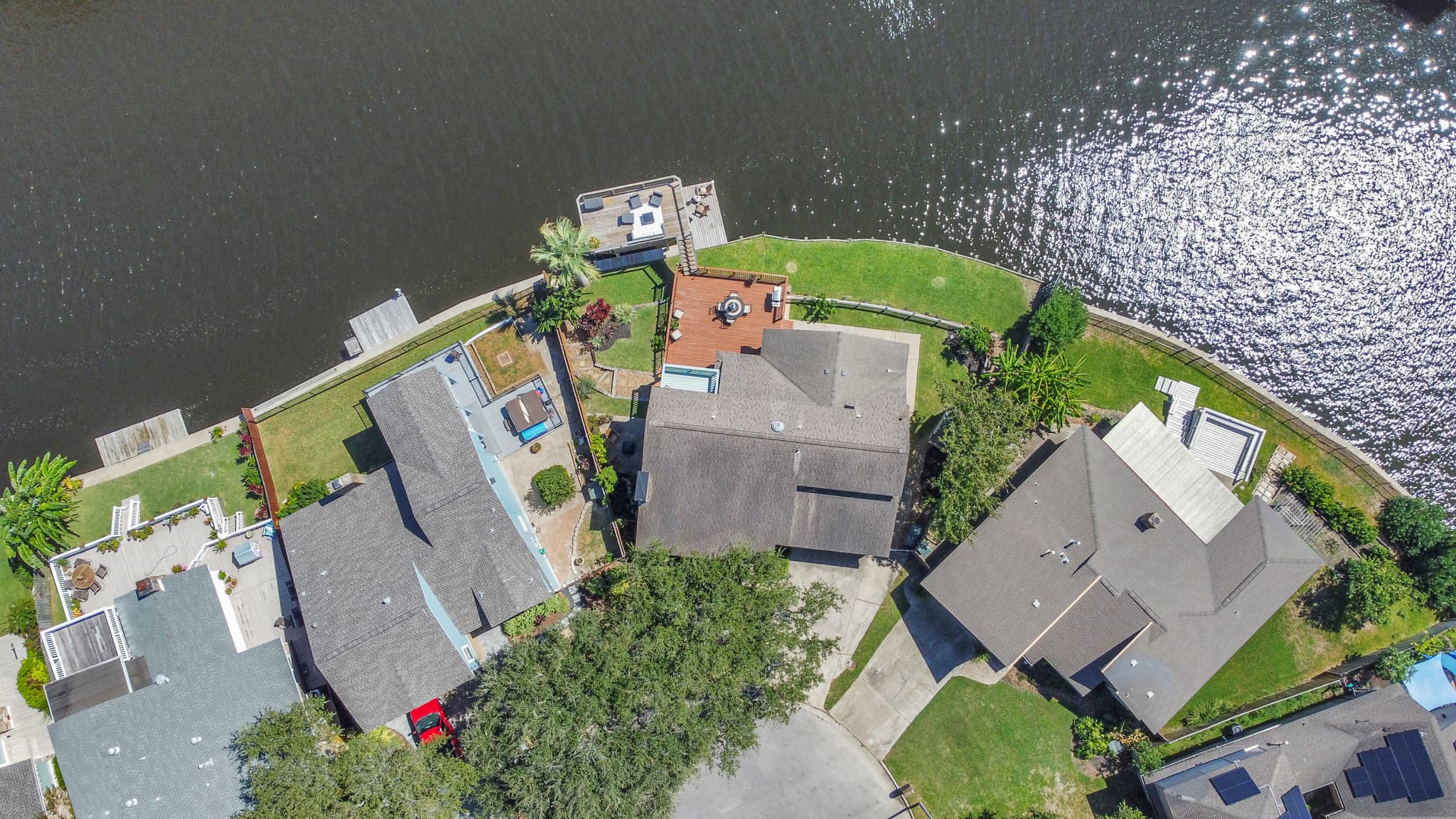 Directly above Lakeview Landing — the private dock, covered boat lift, and multi-level deck on Madeline Lake are all visible from above.