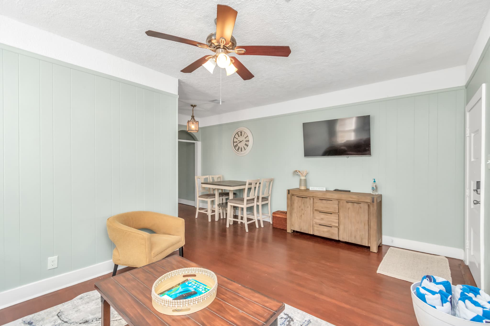 Full living room with smart flat screen TV opens up to the dining area and kitchen for ease of use.