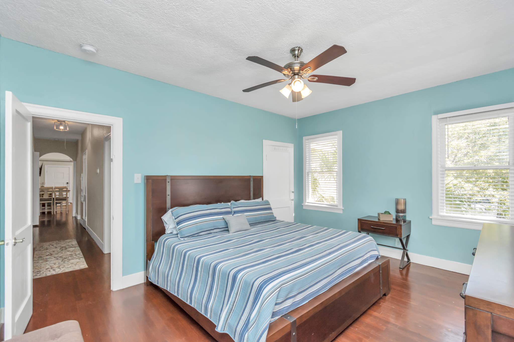A king size bed and hard wood floors, awaits for a great night sleep.