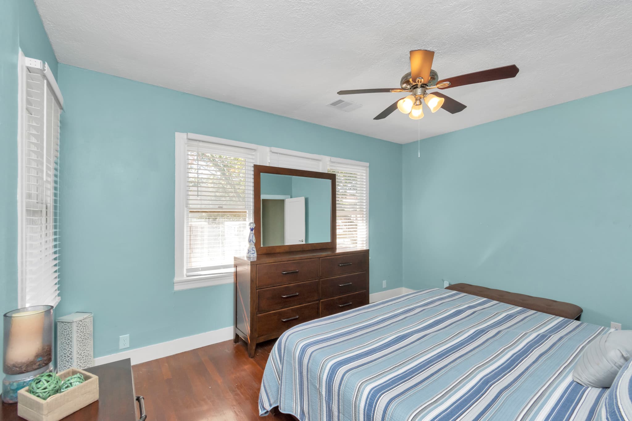 A view of the backyard from the king size bed with ceiling fan to keep you cool and relaxed.
