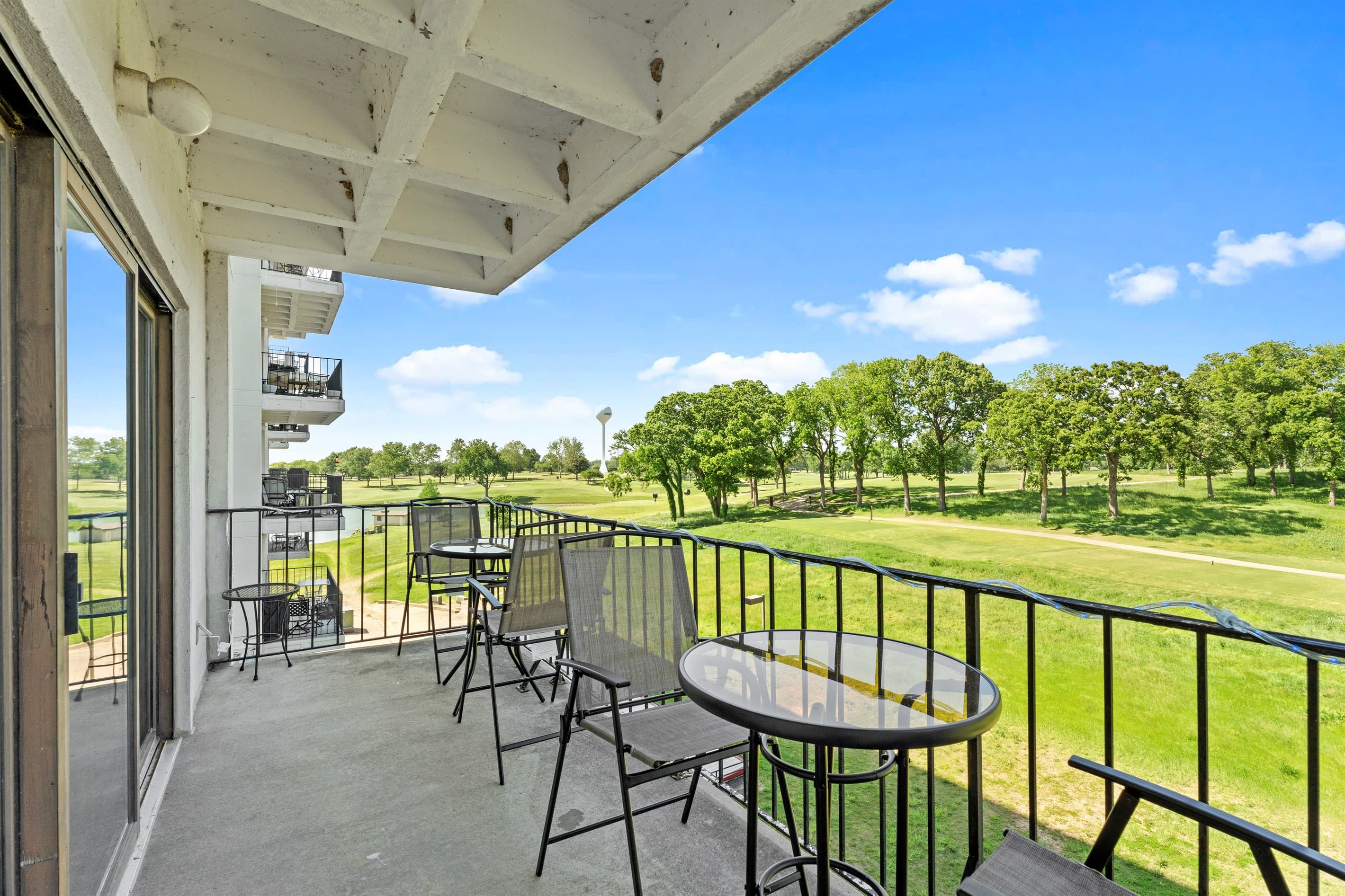 balconey with 2 tables and 4 chairs