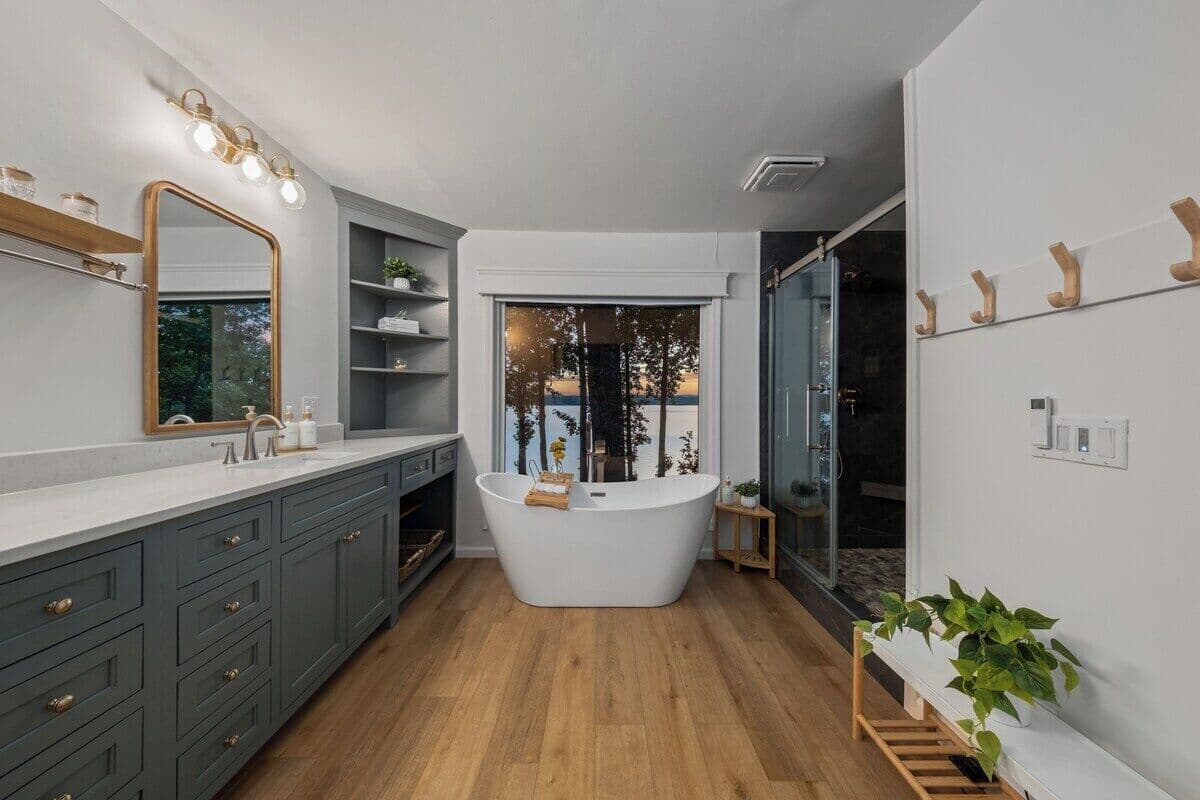 Master Bathroom with soaking tub, 2-person stone shower, his/her sinks, and toilet