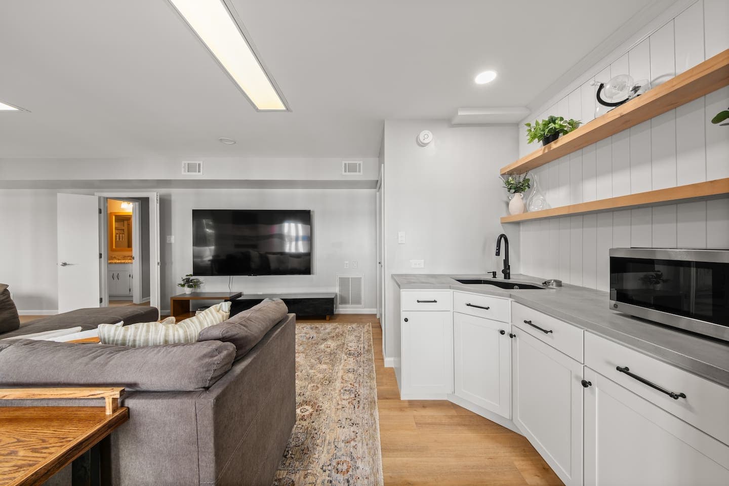Kitchenette with a full fridge and stocked with an electric skillet, a griddle, coffee maker, and convection microwave oven.