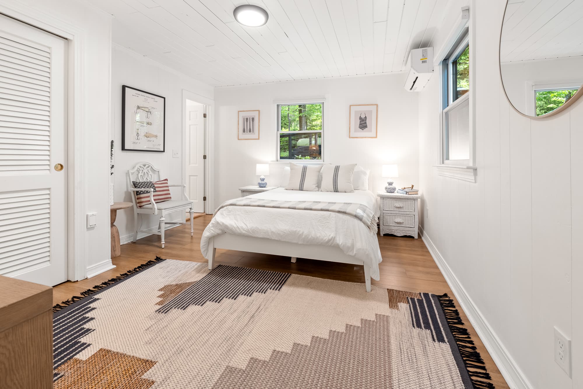 Serene first-floor bedroom w/ soft white finishes