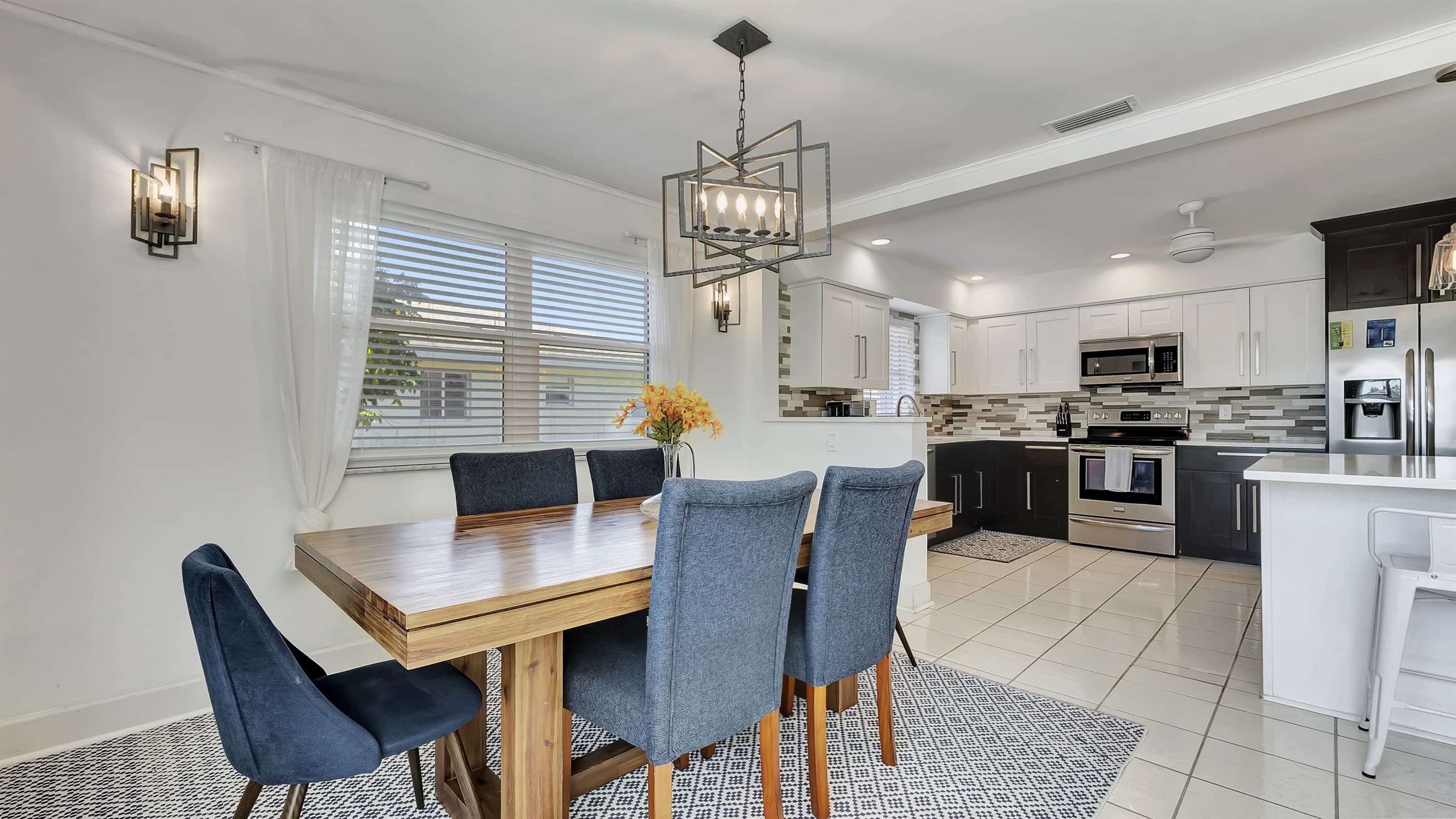 The dining table is conveniently placed next to the kitchen