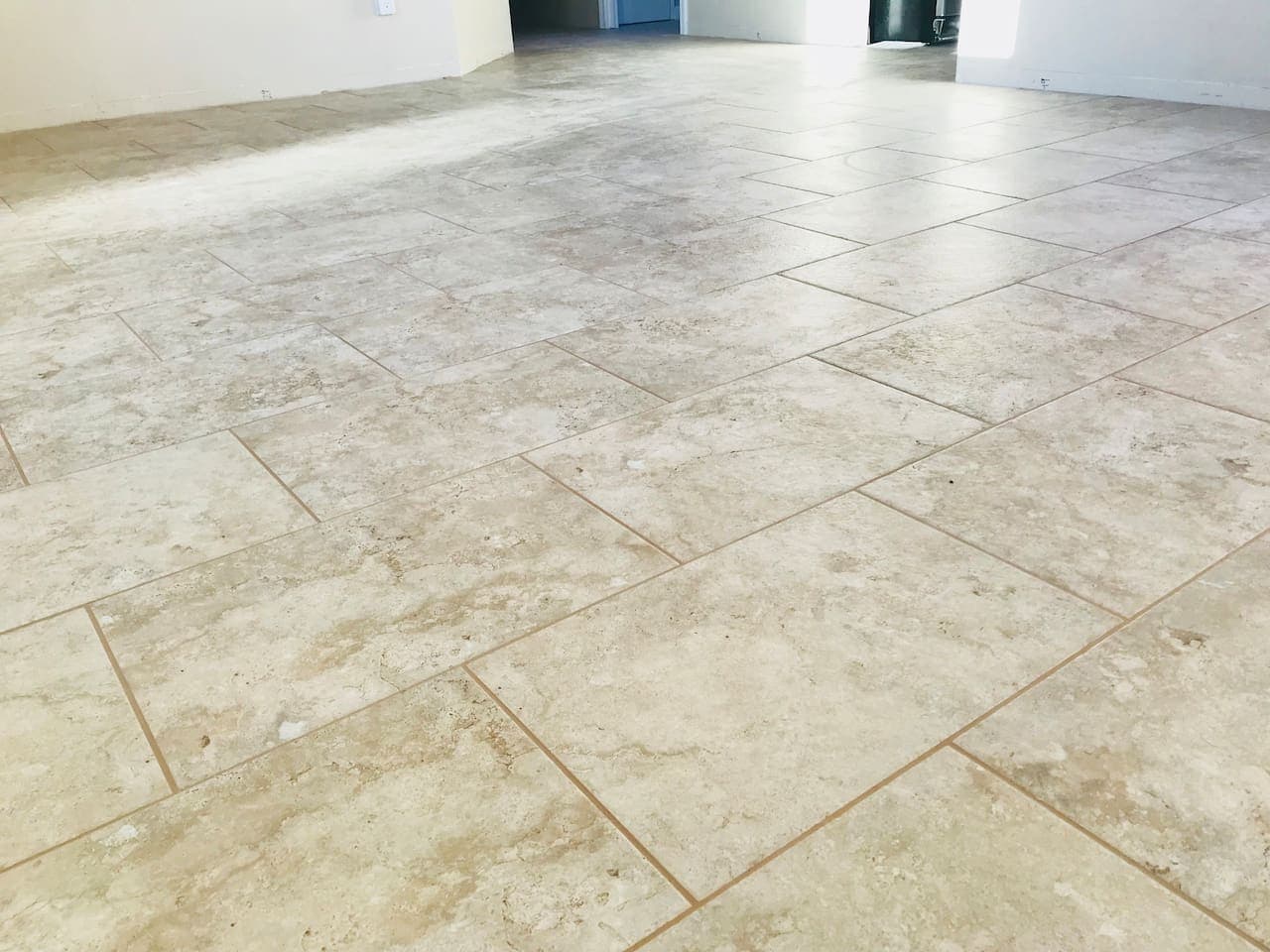 Travertine look porcelain tile floors throughout