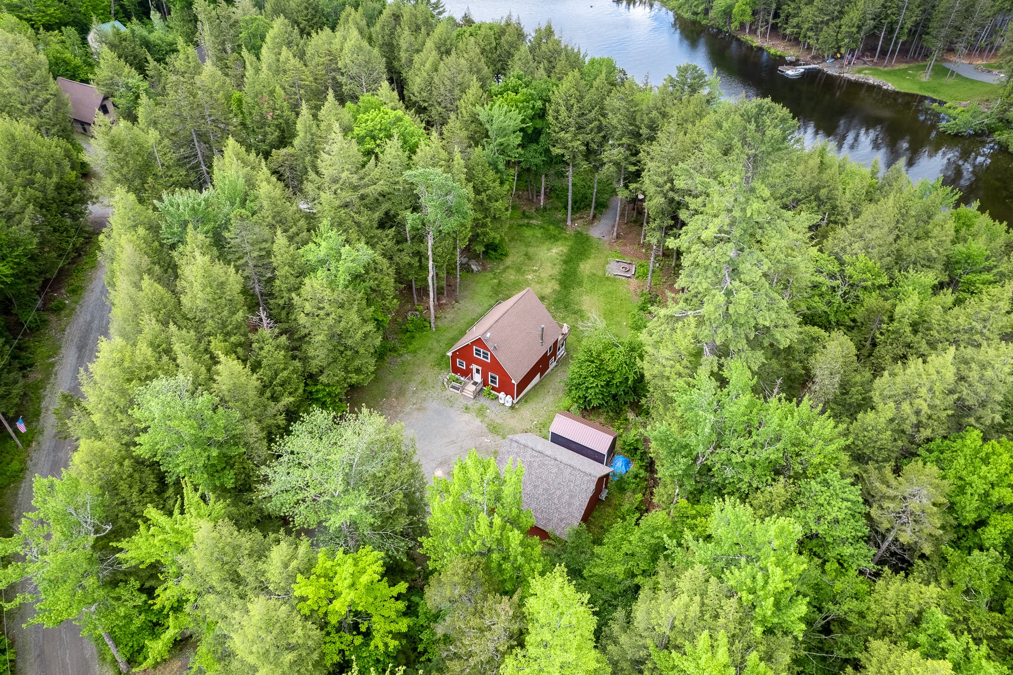 Private lake access with a dock in protected cove, large parking area, large backyard, quiet surroundings.