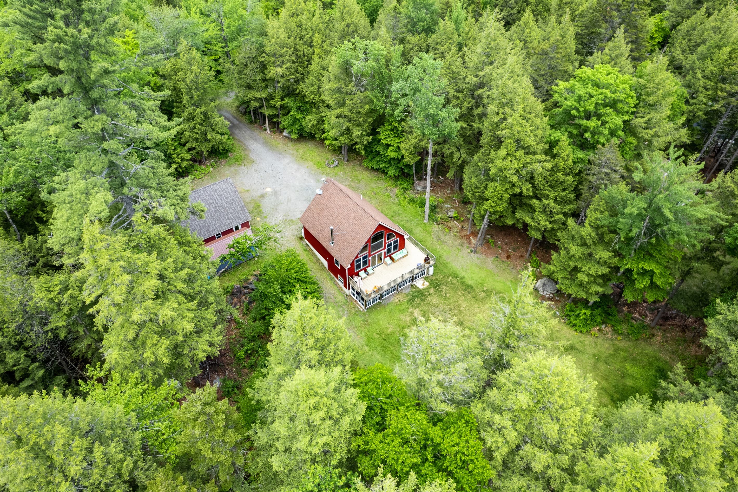 Private lake access with a dock in protected cove, large parking area, large backyard, quiet surroundings.
