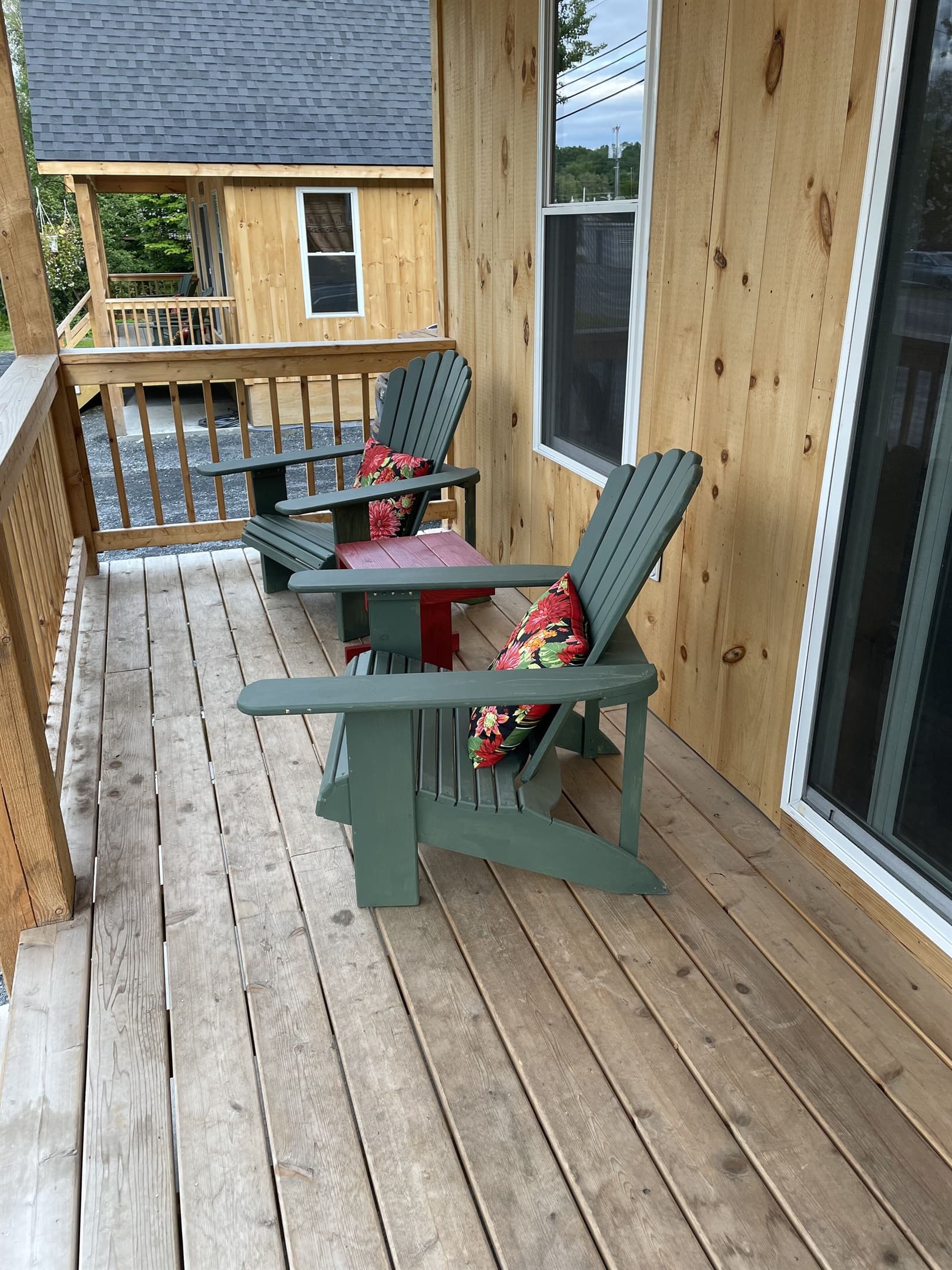 Front porch with Adirondack chairs with access to restaurants, shops, and lake!