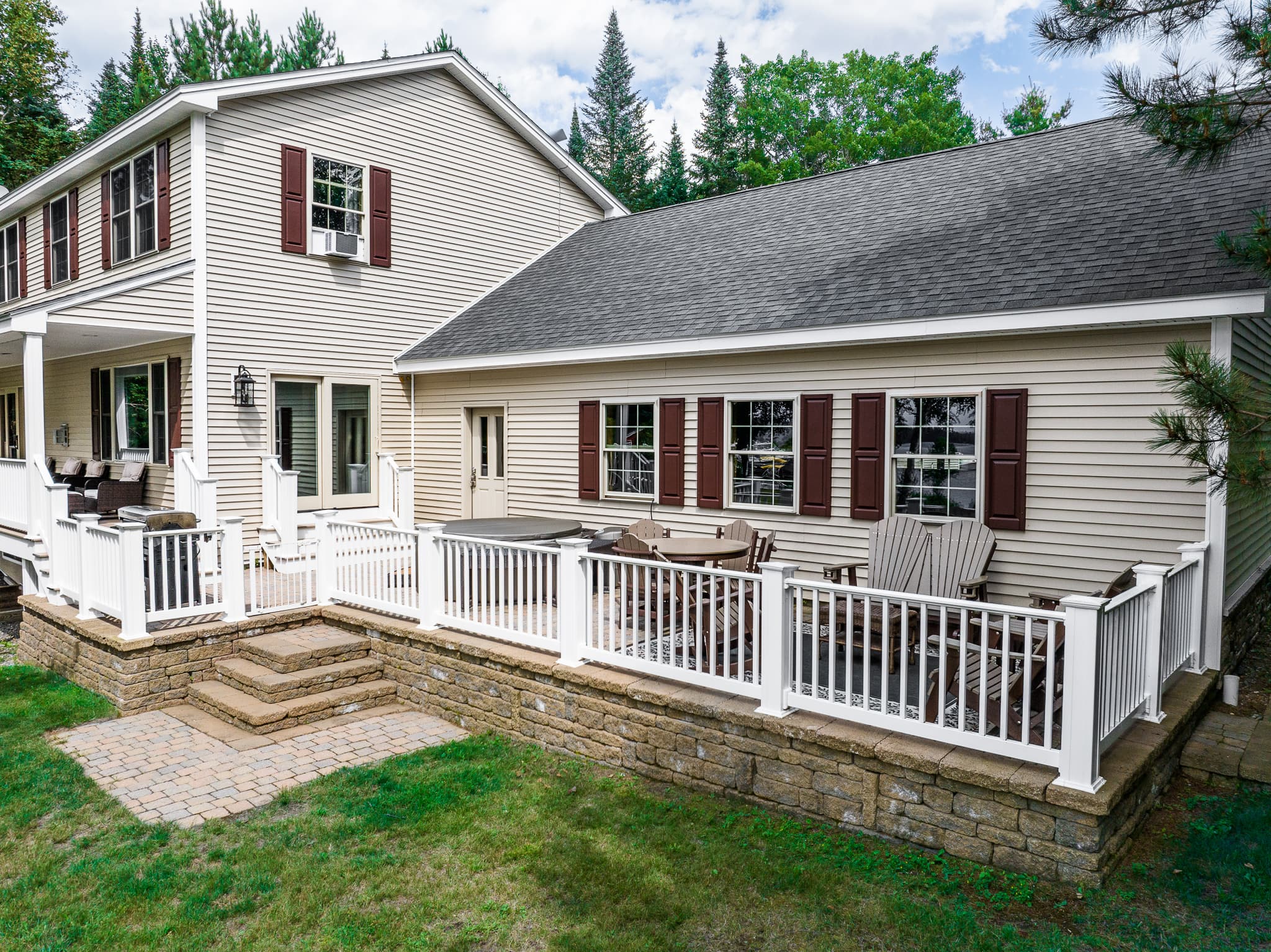 Comfortable seating area on the patio with hot tub, fenced in.