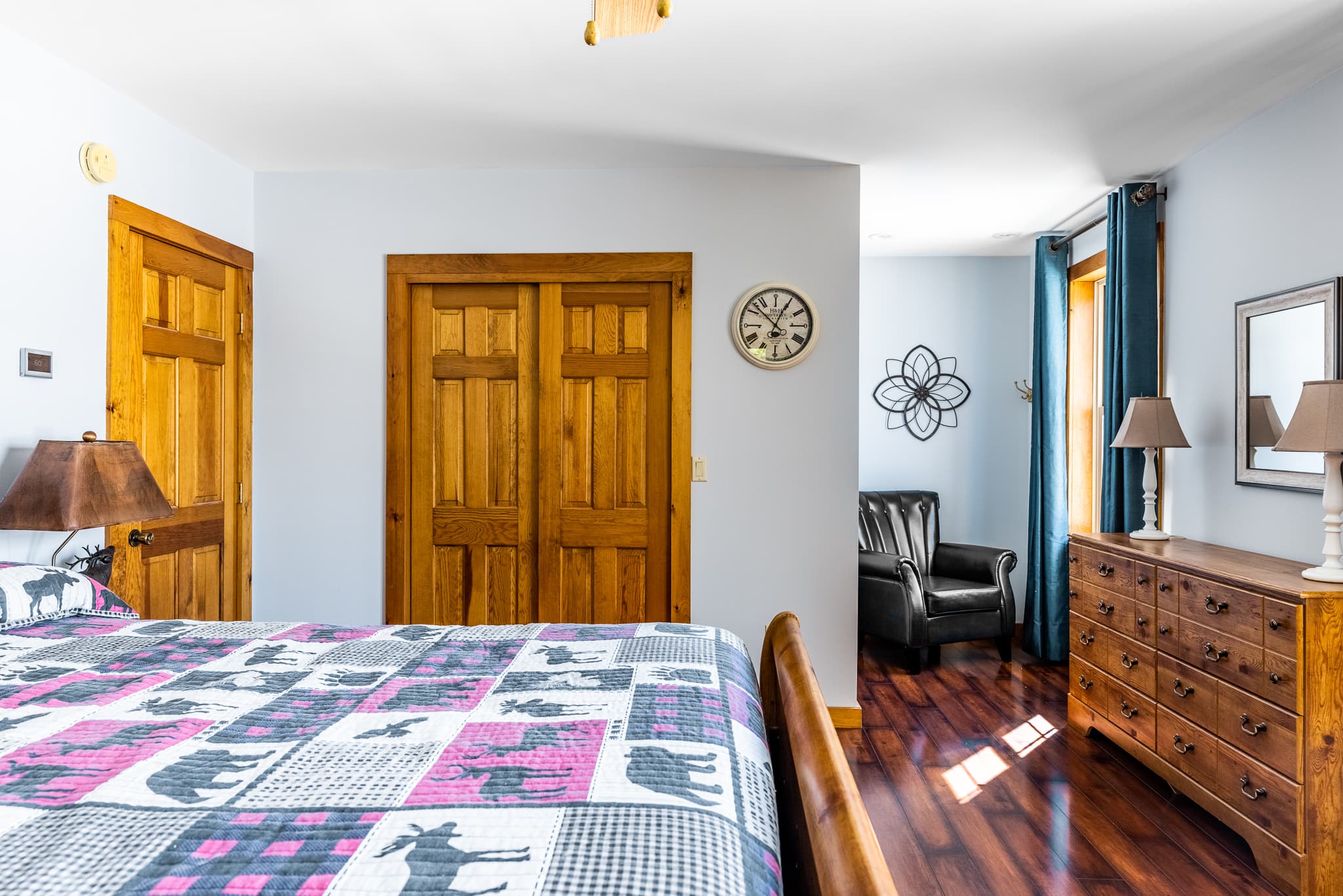 Upstairs bedroom with a queen bed  and reading area overlooking the lake