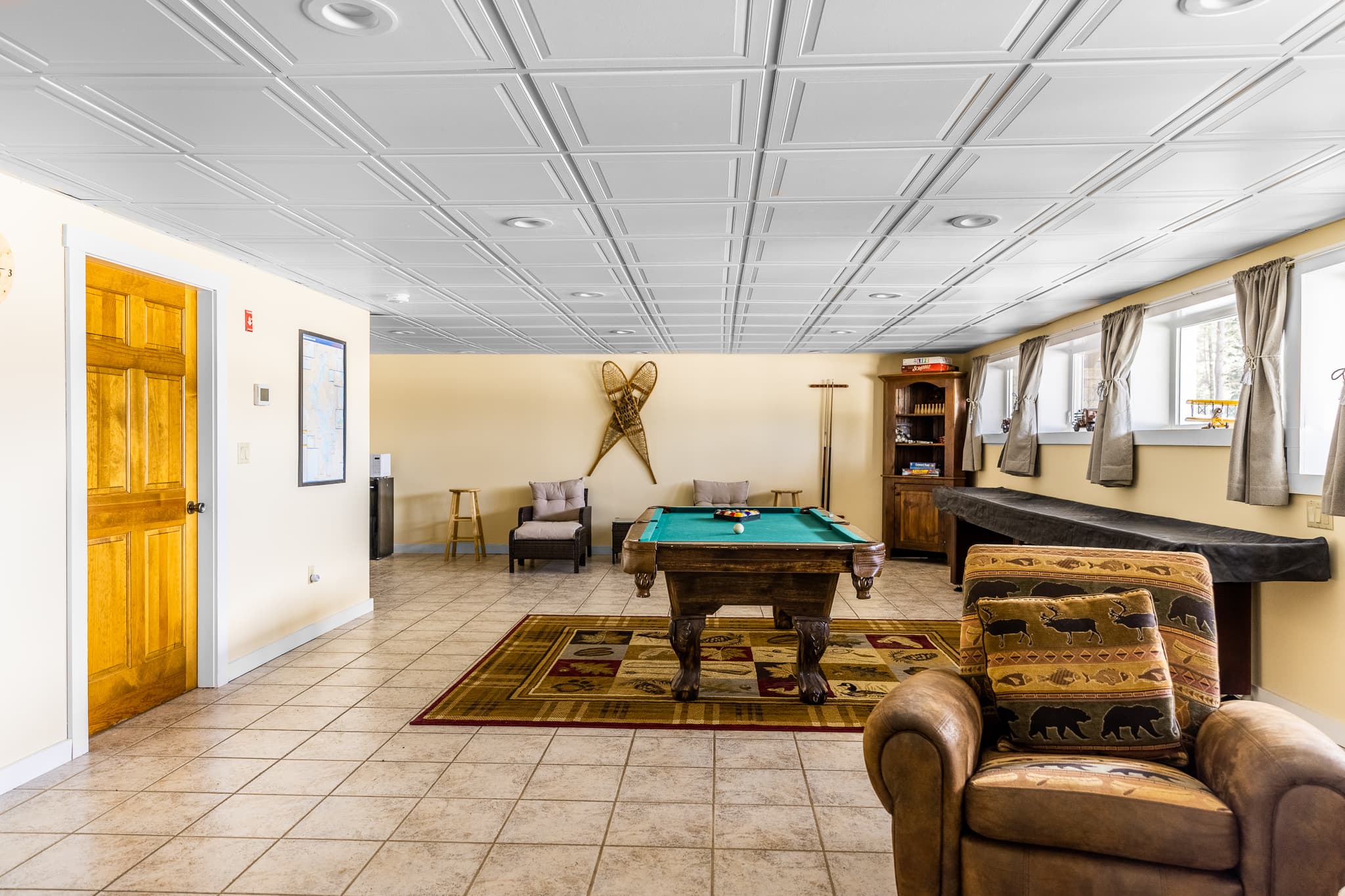 Game room: pool table, ping pong table, shuffleboard table, games, TV, sleeper sofa.