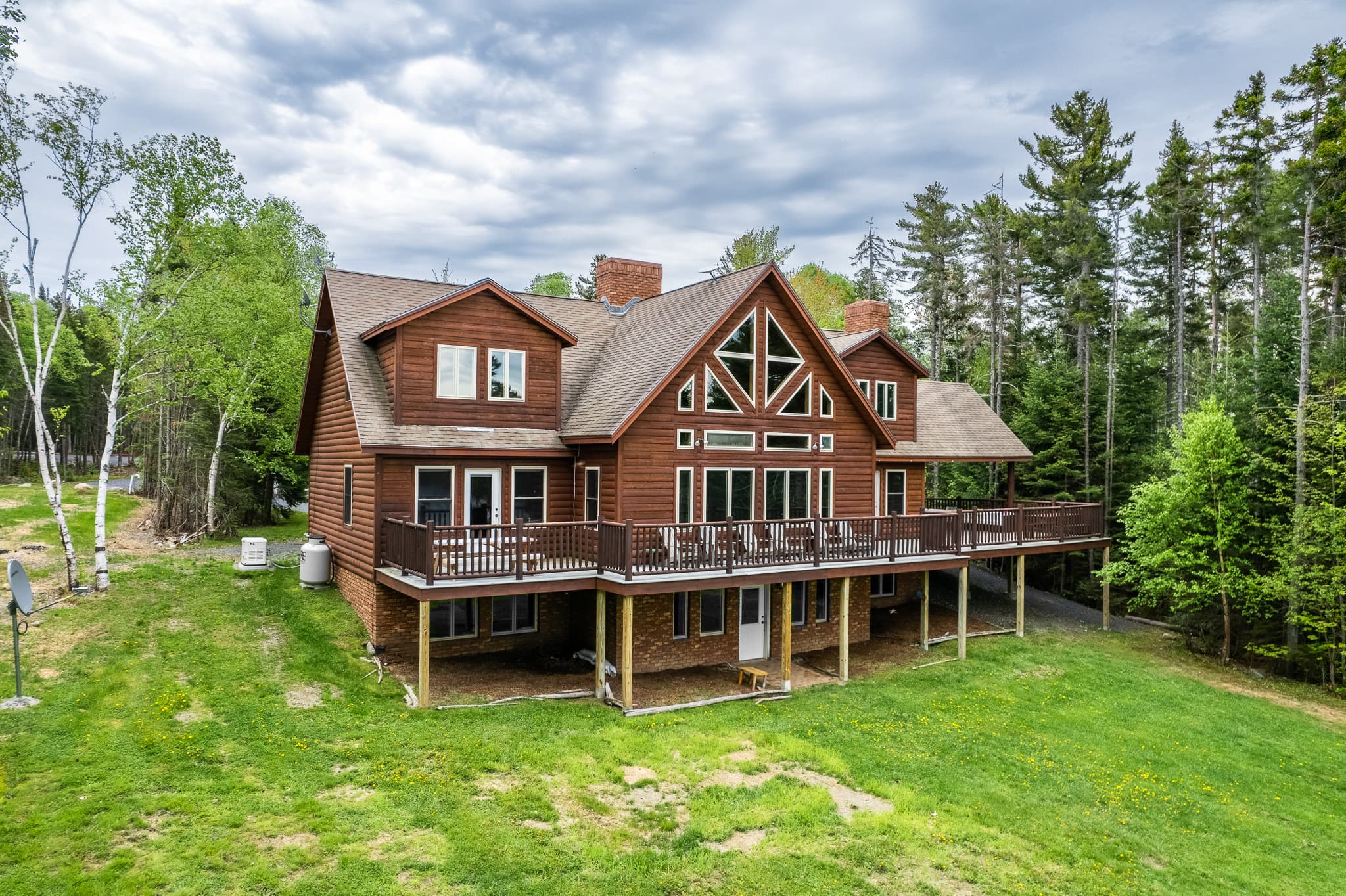 Escape to the back yard overlooking beautiful Lily Bay with amazing sunsets. Play a game of corn hole, gather by a crackling fire with 2 fire pits, or lounge by the your private dock and read a book. An enjoyable spot for everyone to hang out.