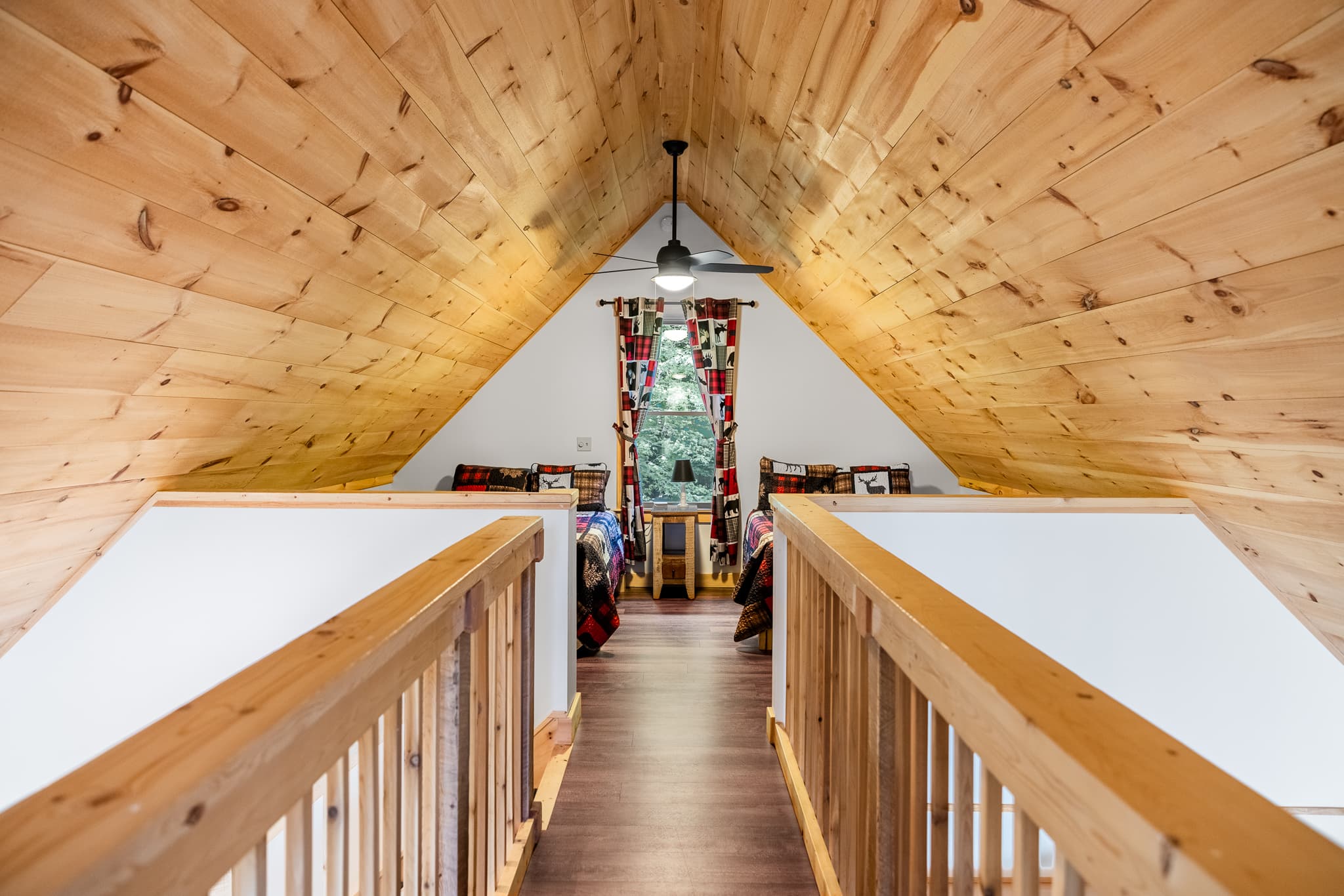 Cat walk connecting 2 sides of the loft, each side with 2 full beds.
