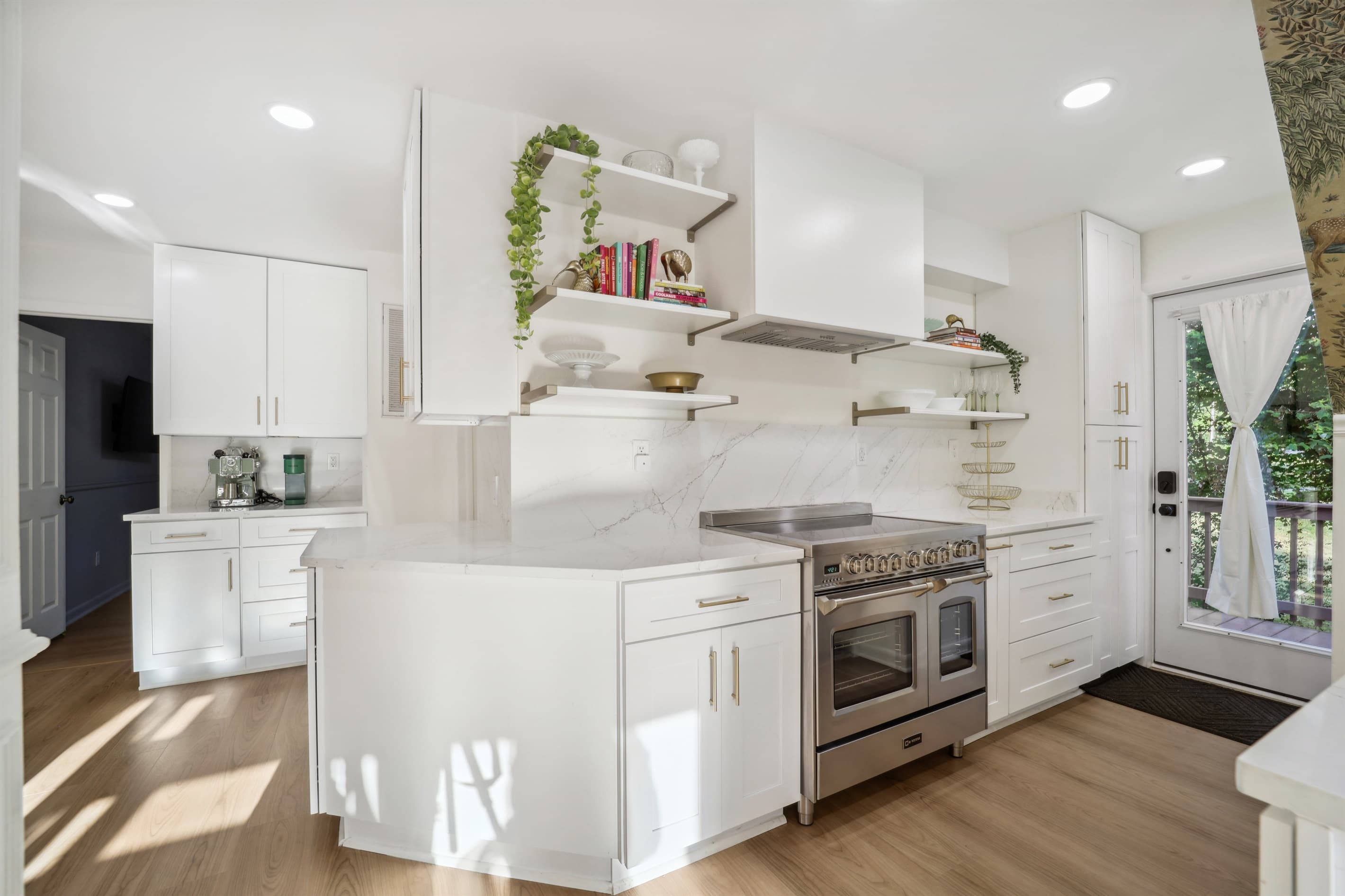 The kitchen has plenty of cabinets and open shelving for plenty of storage! Make yourself at home in the open concept kitchen that makes prepping a meal a dream!