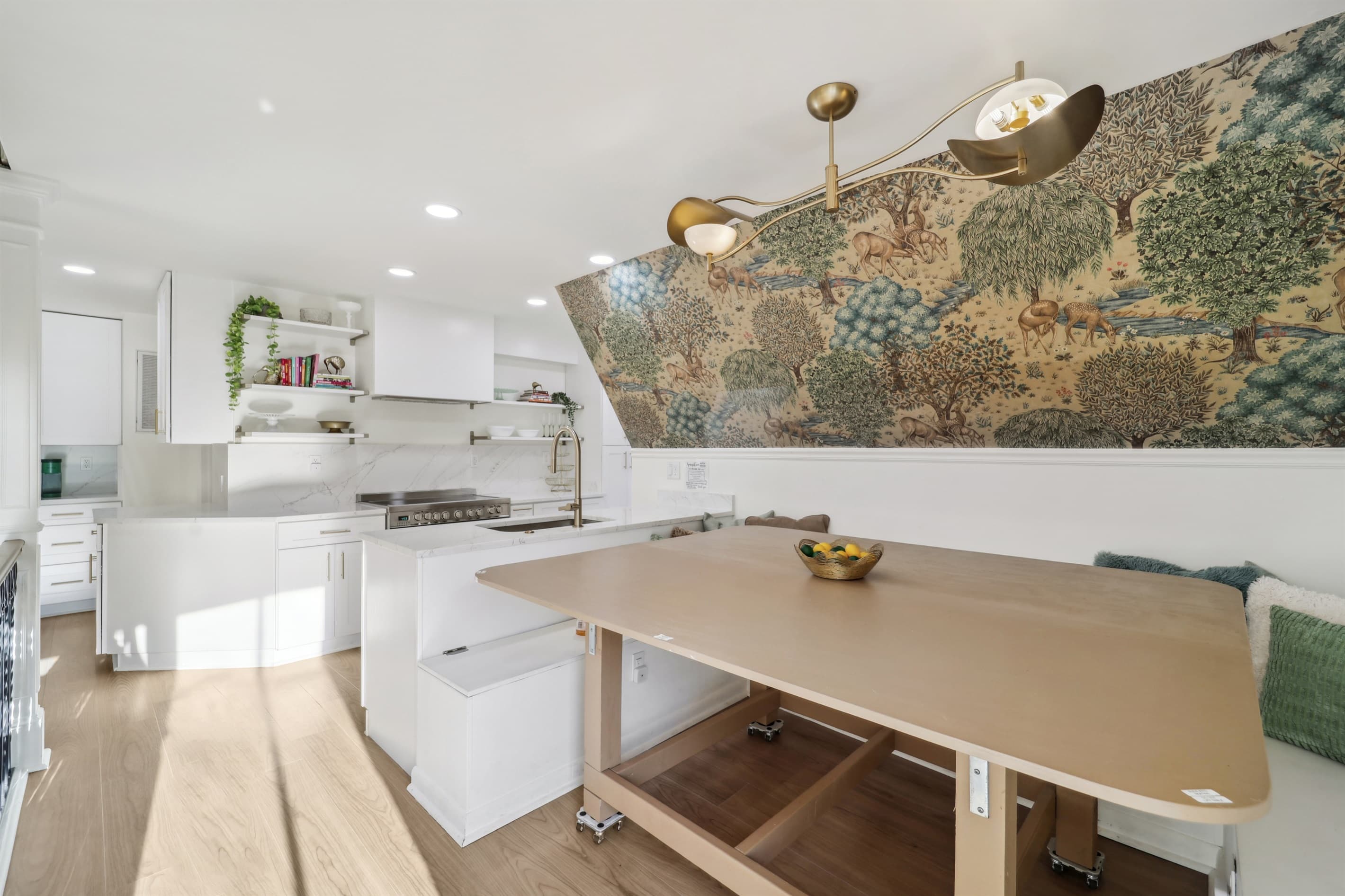 Make beautiful memories in the dining nook which is decorated with a beautiful nature inspired wallpaper and unique chandelier.