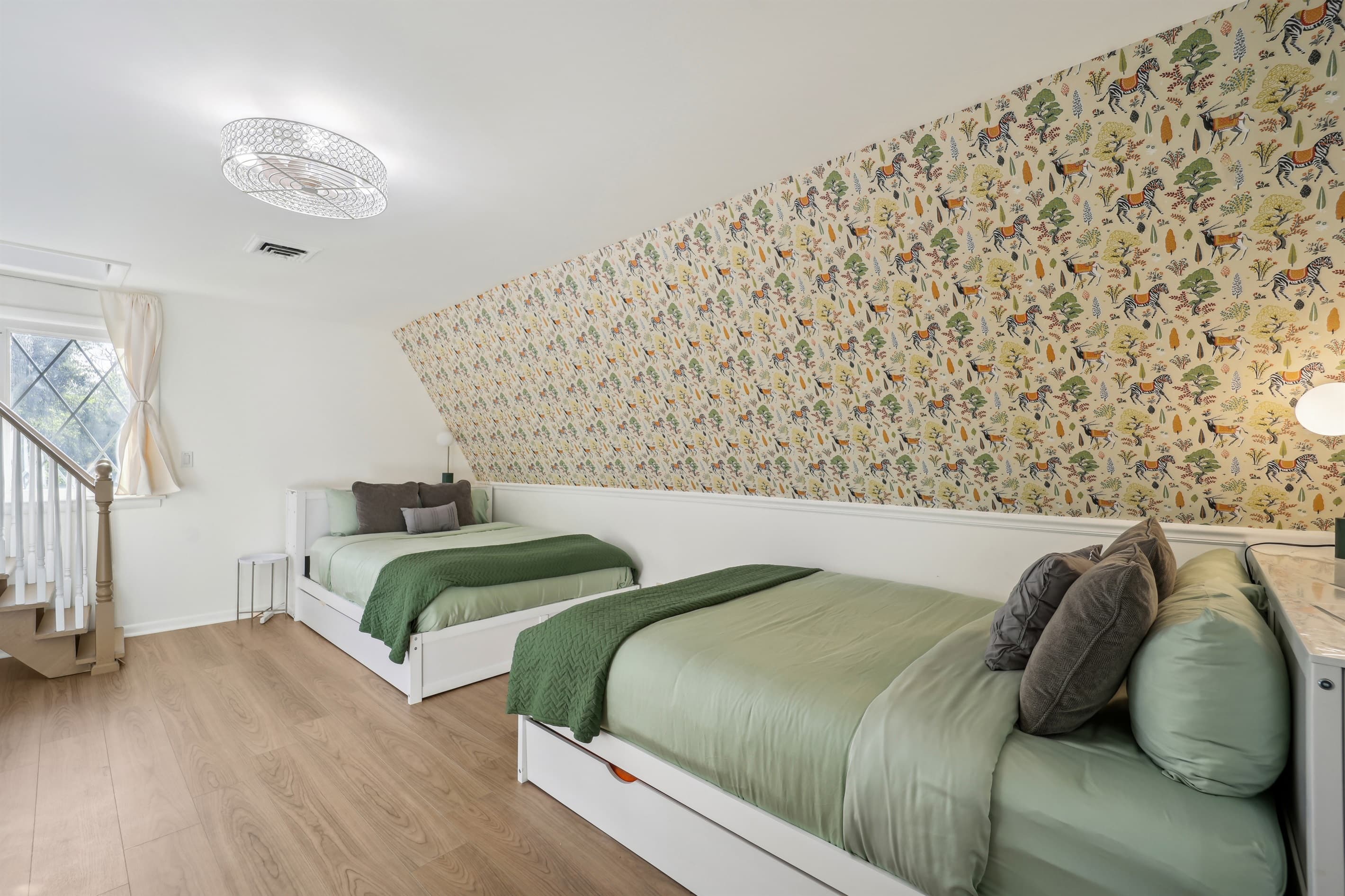 The bedroom connects to the theme room in the attic via a stairway.
