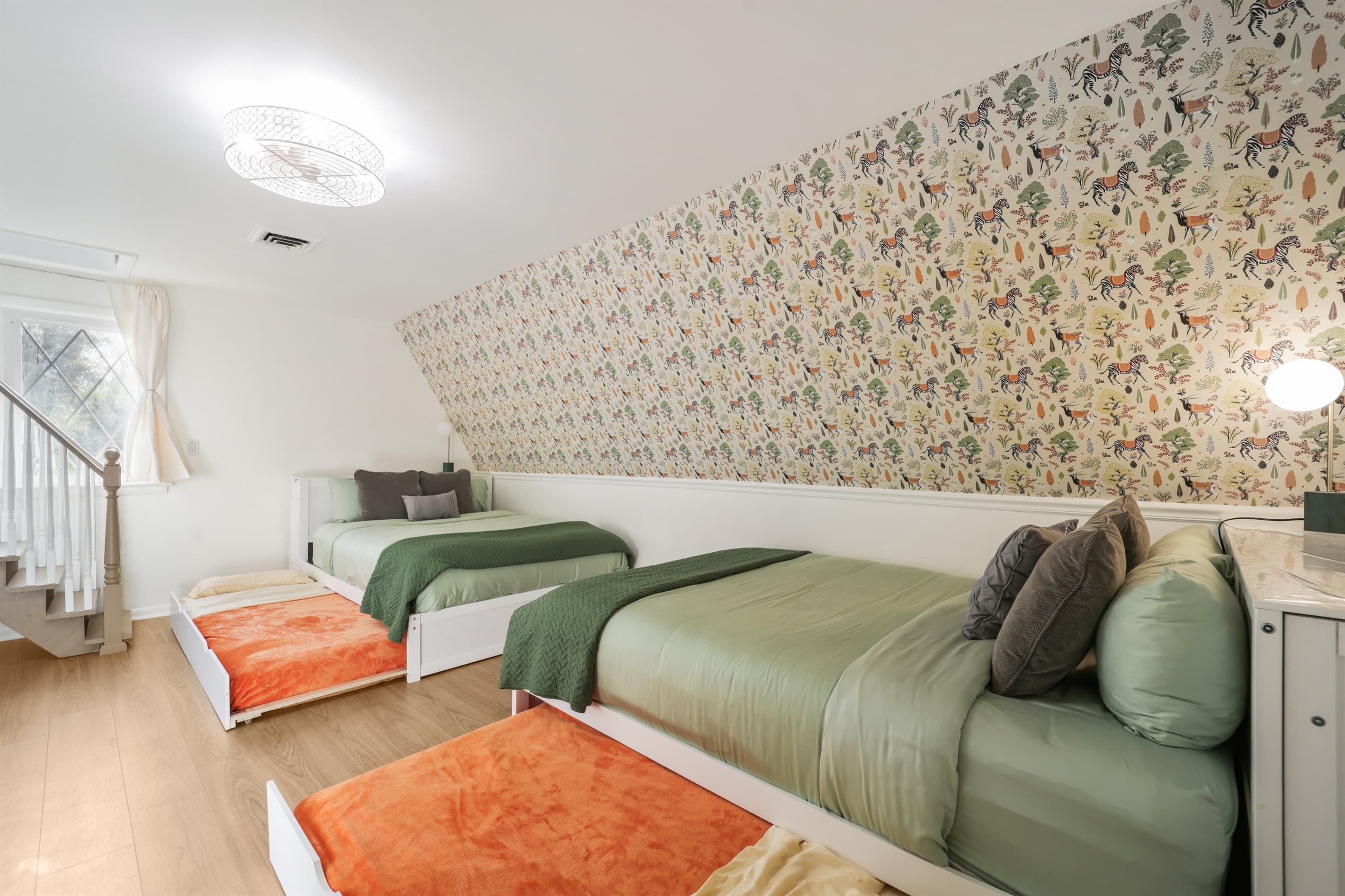 This charming upstairs bedroom with fun wallpaper and plenty of sleeping options is a hit with families and groups. This room can comfortably sleep up to six people.