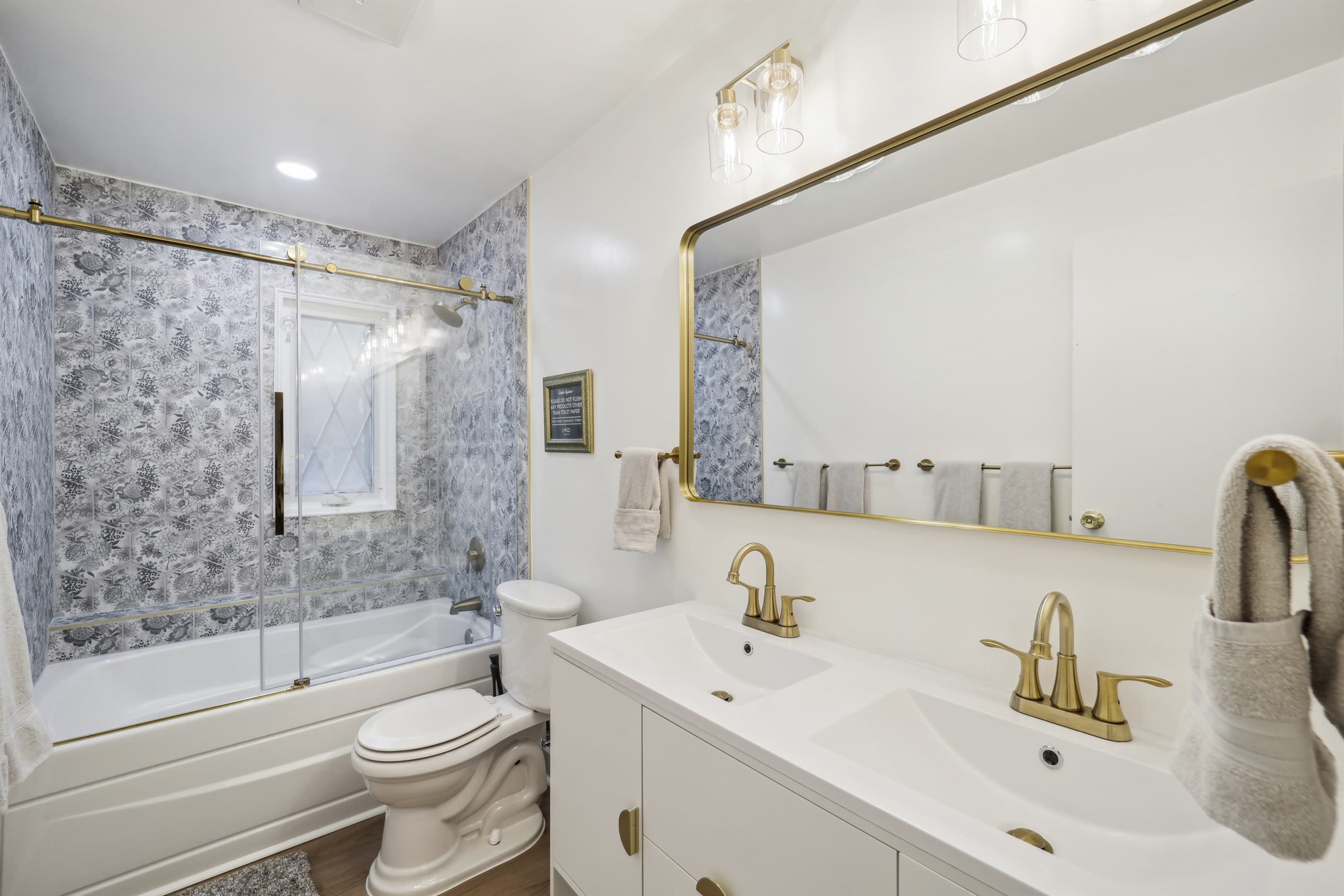 This charming upstairs primary bedroom en-suite bathroom is equipped with a double vanity and soaking tub.