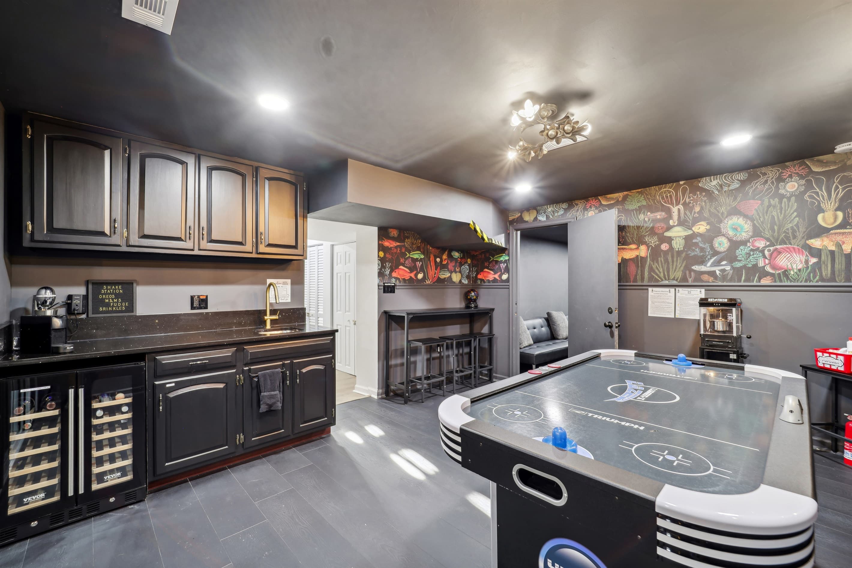 The bar area comes equipped with a wine and beverage refrigerator.