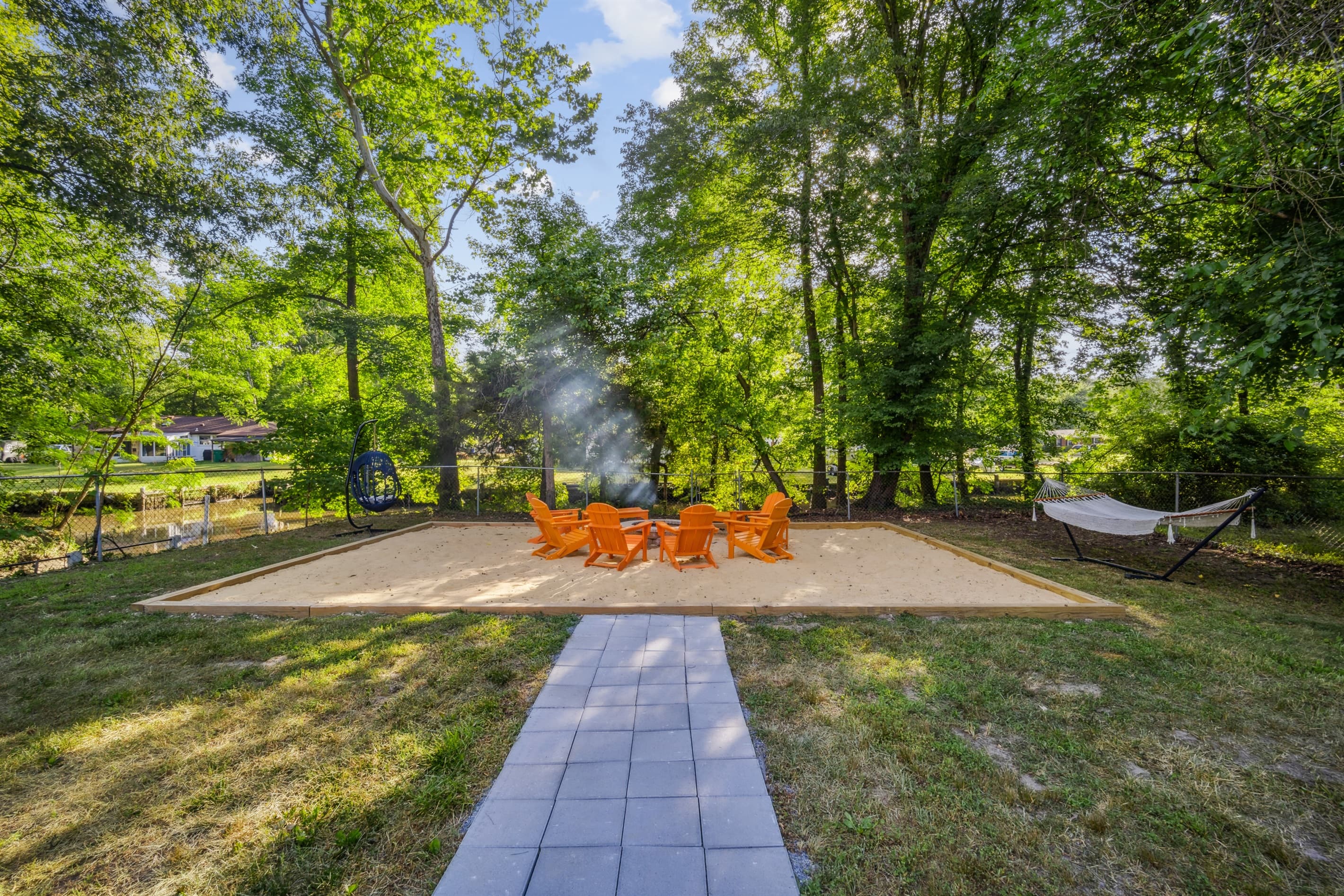 A paved pathway connects the fire pit to the house, so you don't have to walk on grass