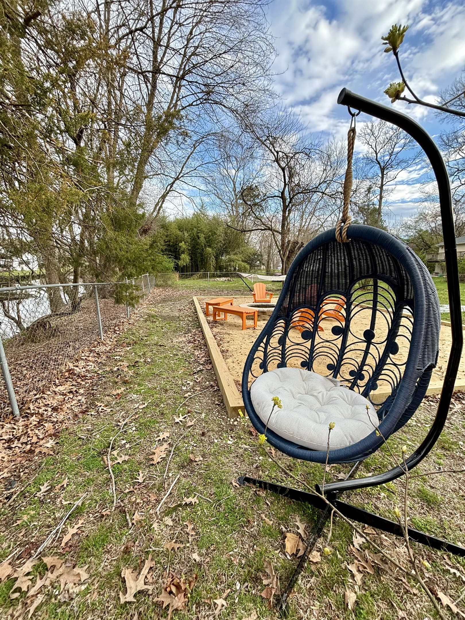 Keep an eye for birds or read a book as you swing on the egg chair by the river.