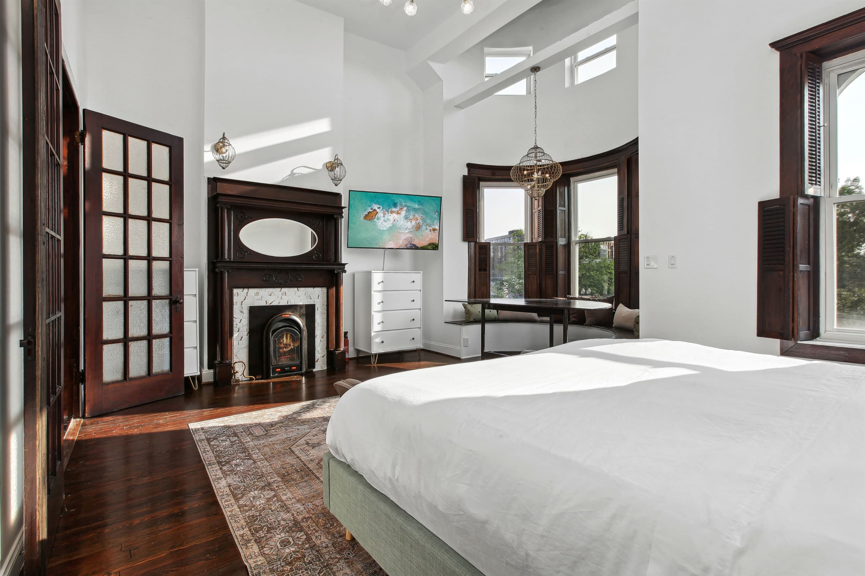 The primary bedroom also has its own mantel and fireplace along with a 58" Roku TV