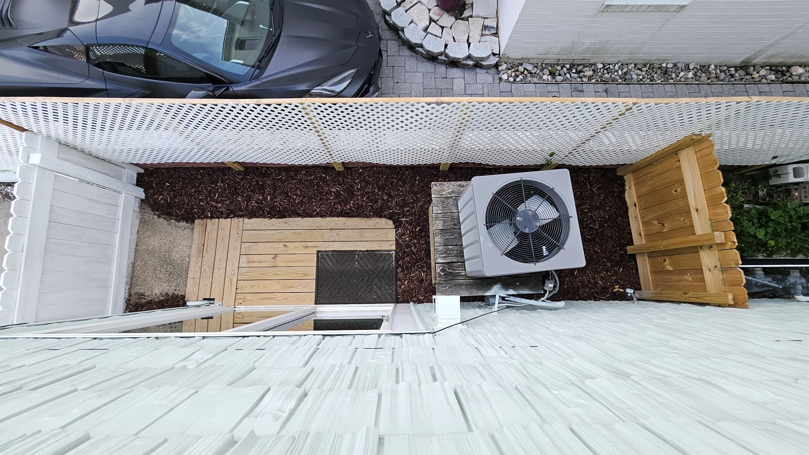 Overhead view of fully-fenced small side yard for pets that's just off the living room through a sliding glass door