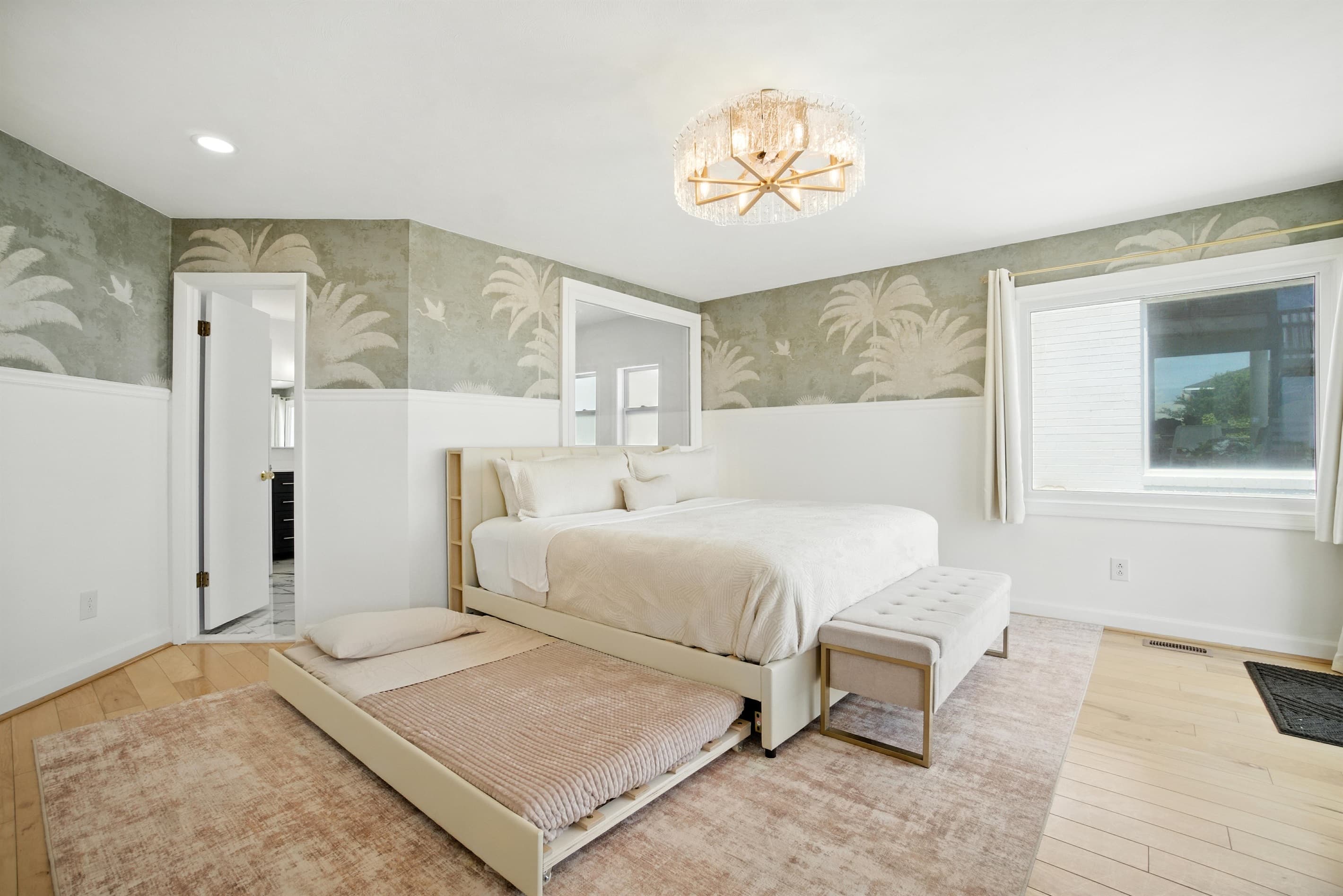 Primary Bedroom has a Twin trundle bed underneath the main bed