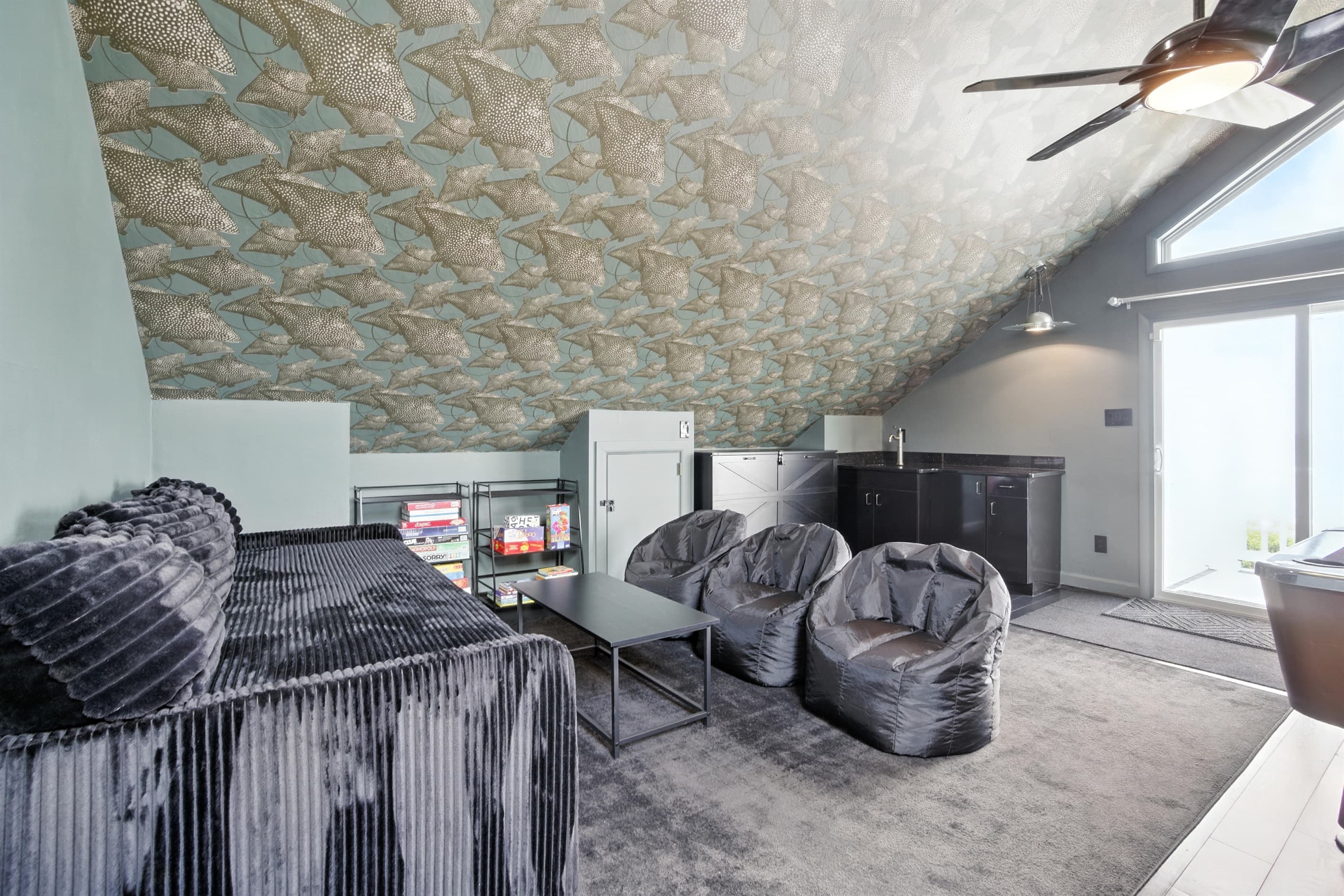 Game Room has a Twin Day Bed and Bean Bag seating, in addition to Bar Stools, at the top level of Unit A