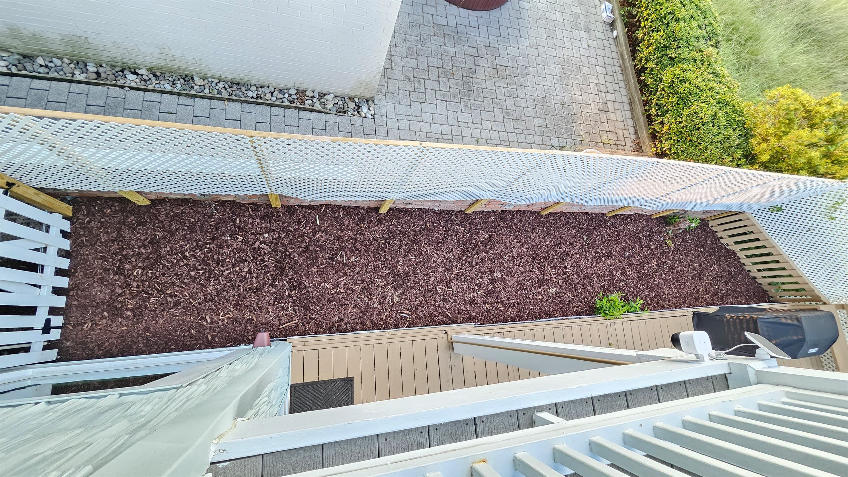 The side of the backyard has a mulched area for pets