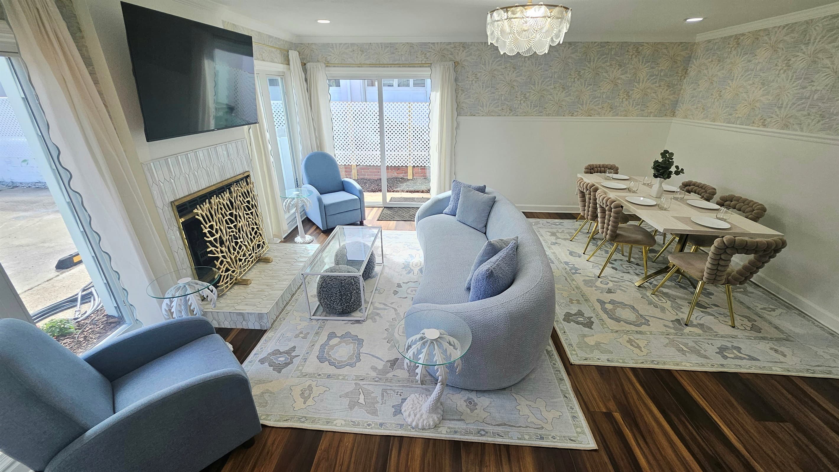 Unit B - Living Room with curved couch, electric fireplace and big screen Roku TV