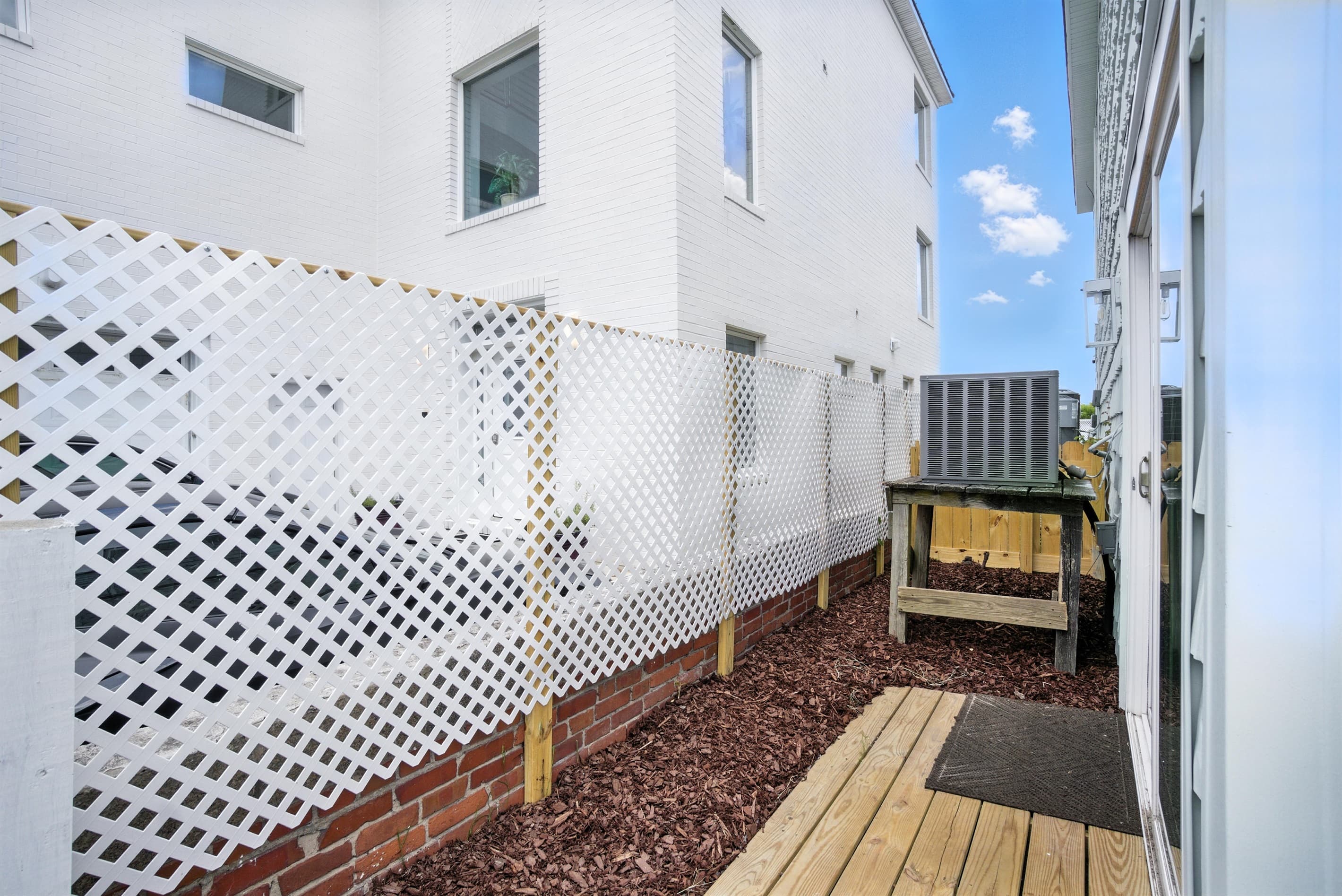 Fully fenced side yard in Unit B is off the living room via a sliding glass door