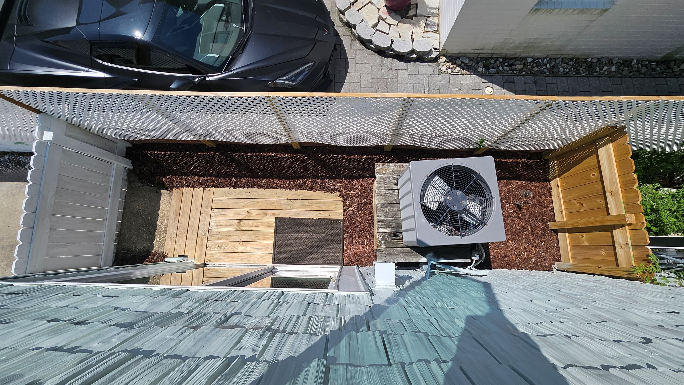Overhead view of fully-fenced small side yard for pets that's just off the living room in Unit B through a sliding glass door